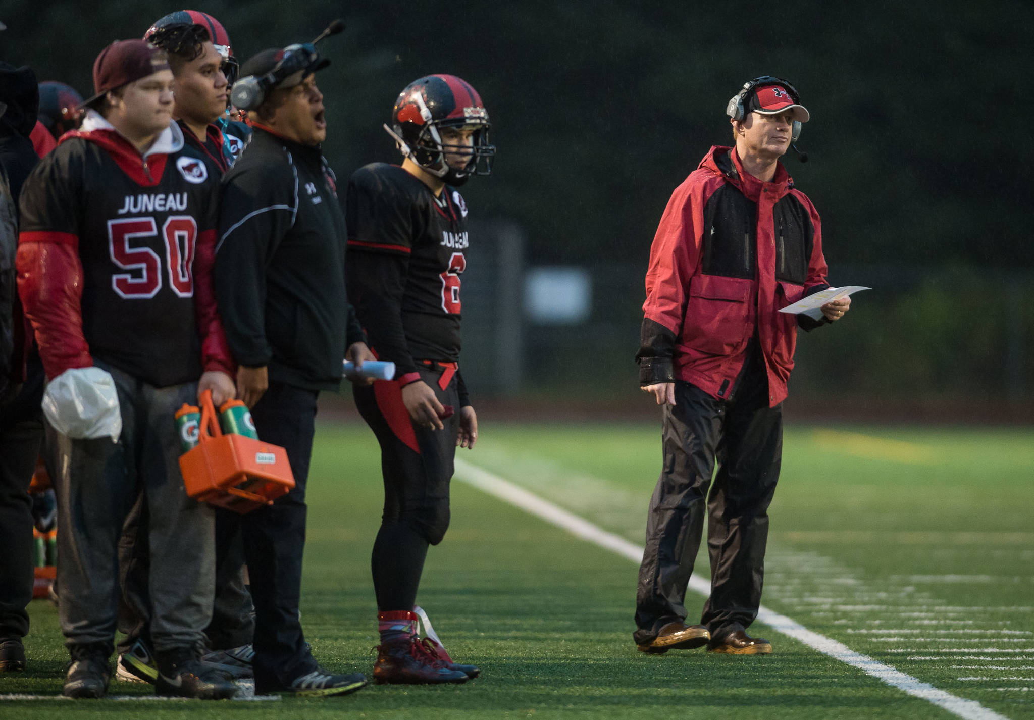 Juneau-Douglas High School football coach Kevin Hamrick, right, watches his team play against North Pole at Adair-Kennedy Memoiral Field on Saturday, Sept. 23, 2017. JDHS lost 22-16. (Michael Penn | Juneau Empire)