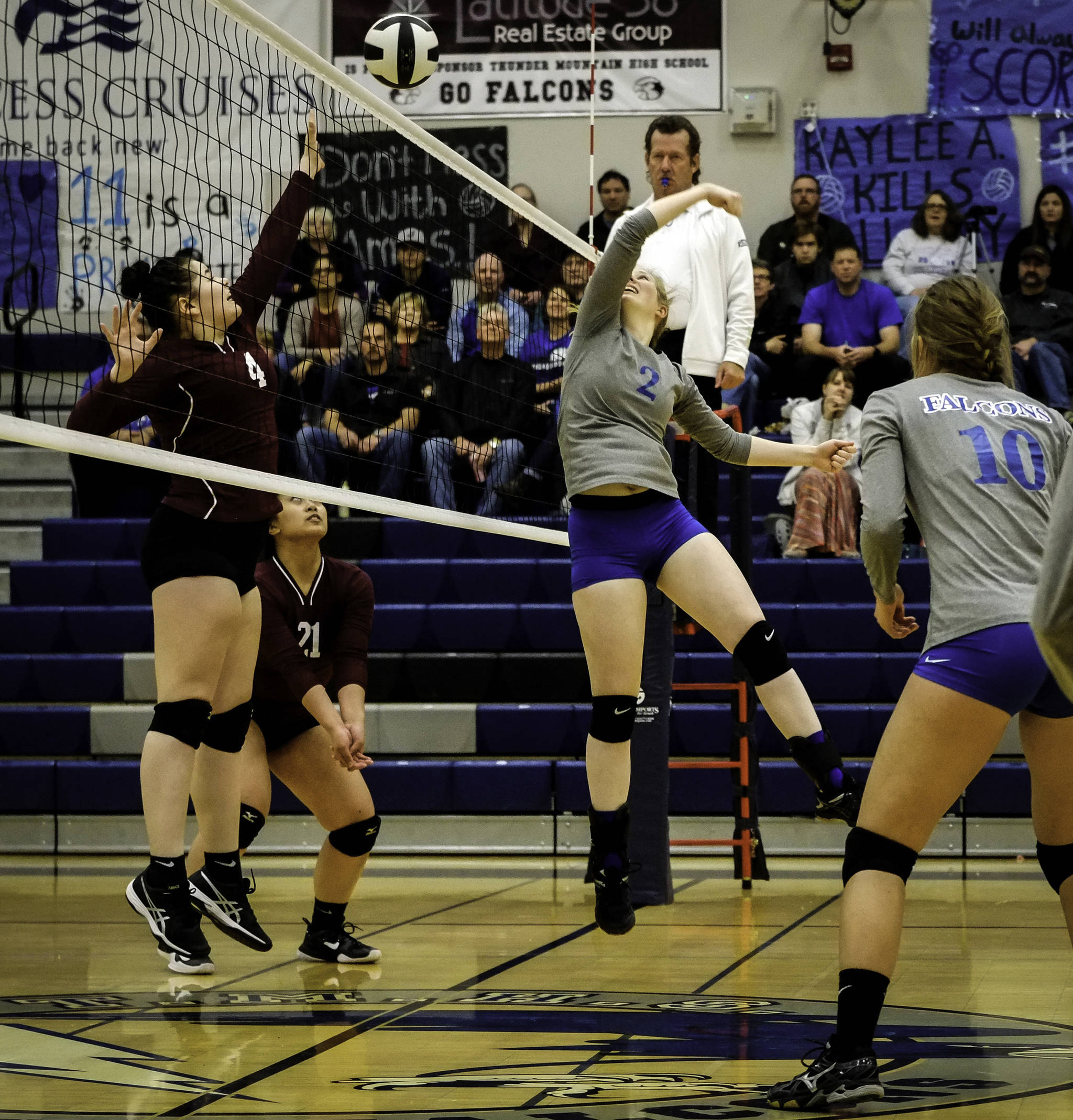 Thunder Mountain’s Mary Landes, right, and Autumn Yeisley, left, of Ketchikan face off at the net during their game Friday at TMHS. The Falcons won in straight sets, 3-0. (Lance Nesbitt | For the Juneau Empire)