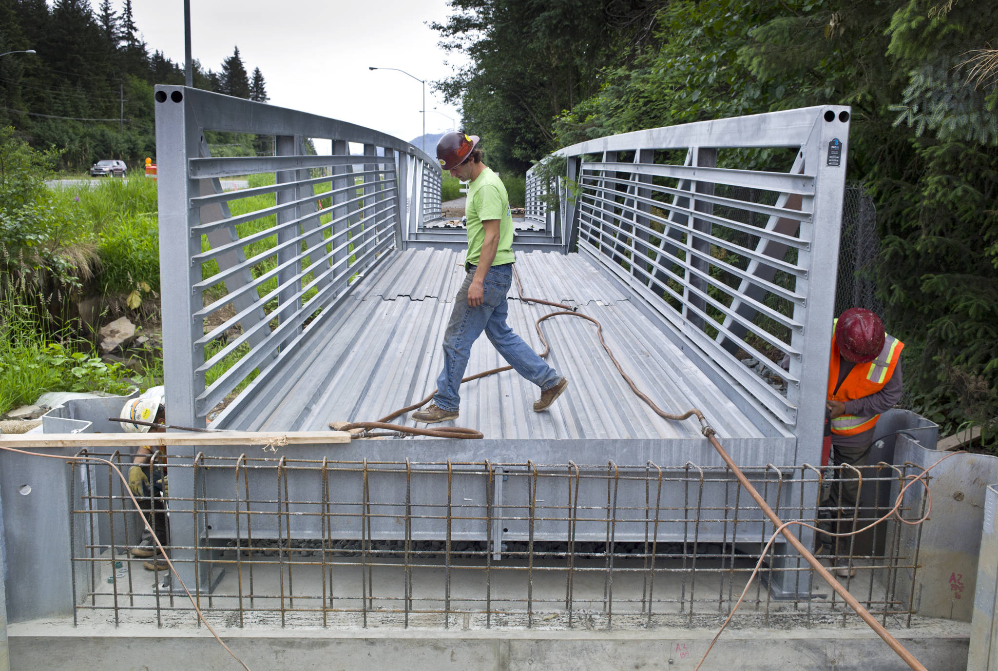 A Trucano Construction crew installs a 94-foot-long bridge over Jordan Creek next to Egan Drive in 2015. A ballot measure debated in Anchorage Superior Court on Tuesday would have significant implications for bridges and other projects that affect salmon-bearing streams.  Michael Penn | Juneau Empire file