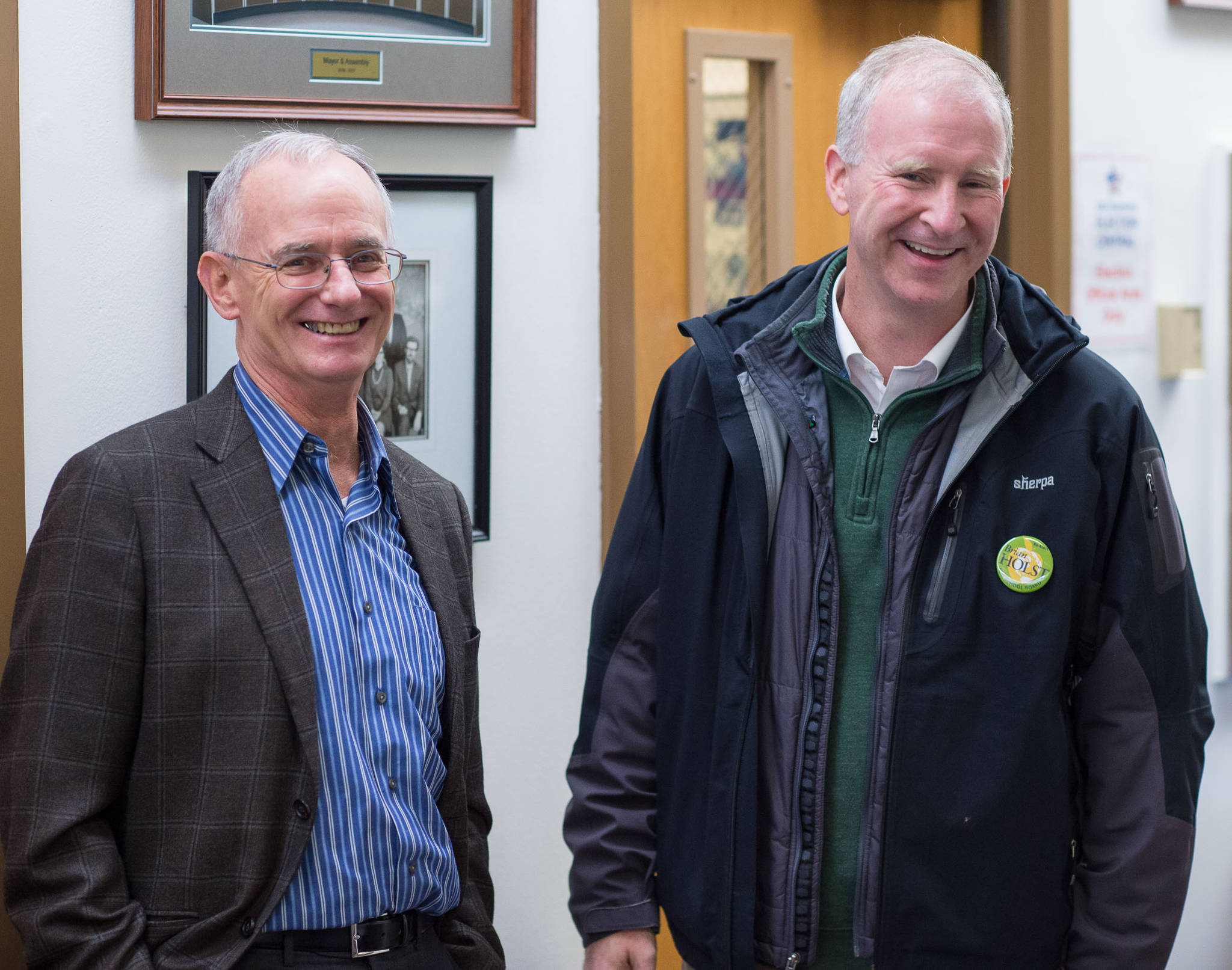 School Board candidates Jeff Short, left, and Brian Holst enjoy their victory at the Assembly chambers on Tuesday, Oct. 3, 2017. (Michael Penn | Juneau Empire)