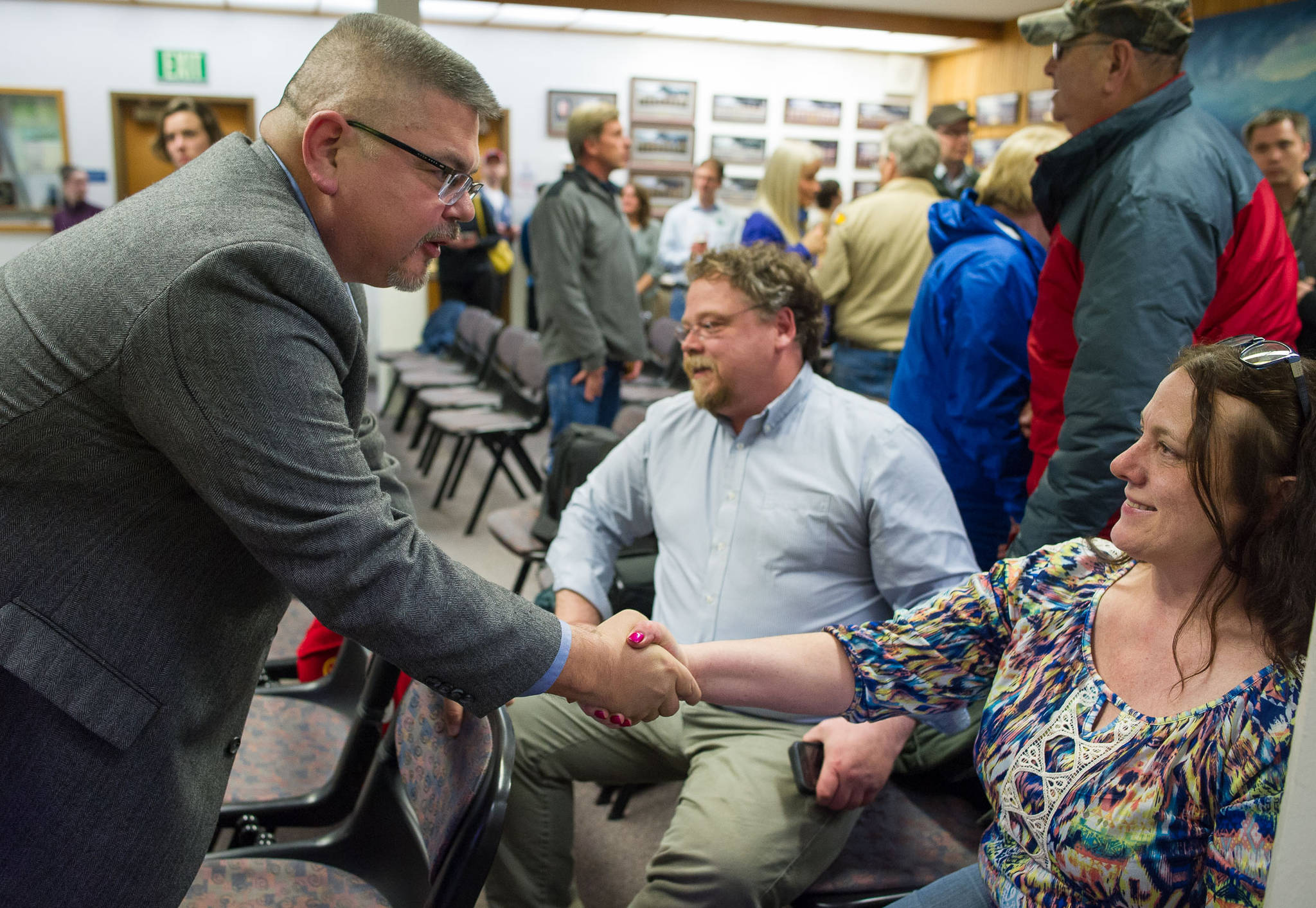Rob Edwardson, left, greets Debbie White after election results showed him winning by a wide margin at the Assembly chambers on Tuesday, Oct. 3, 2017. (Michael Penn | Juneau Empire)