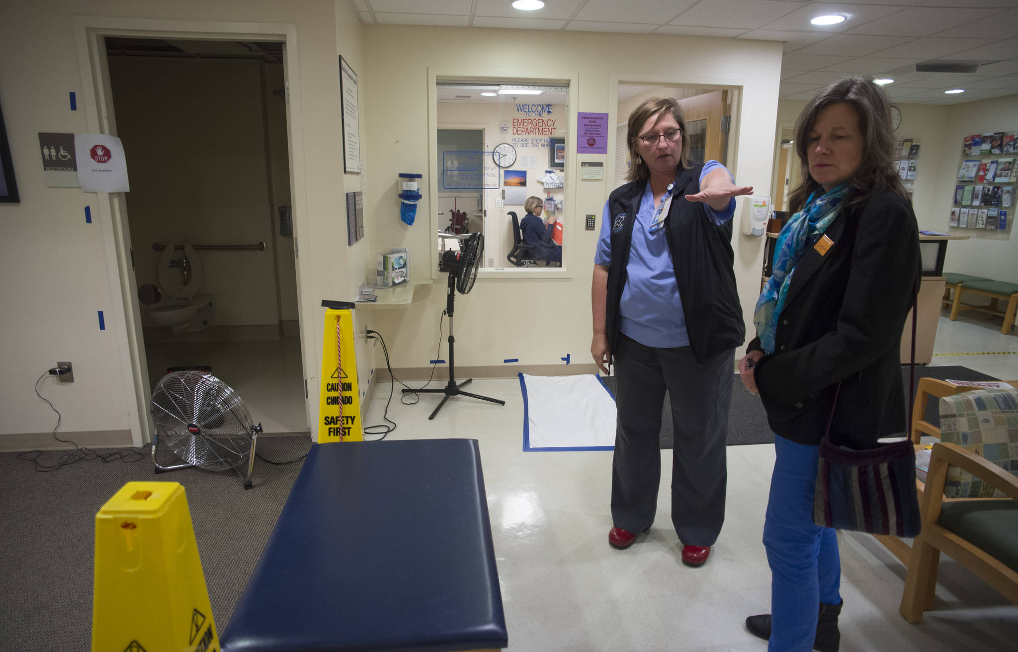 Bartlett Regional Hospital Emergency Department Director Kim McDowell, left, talks to Community Relations Director Katie Bausler on Wednesday about the flooding caused by a fire in the department’s bathroom early Wednesday morning. (Michael Penn | Juneau Empire)