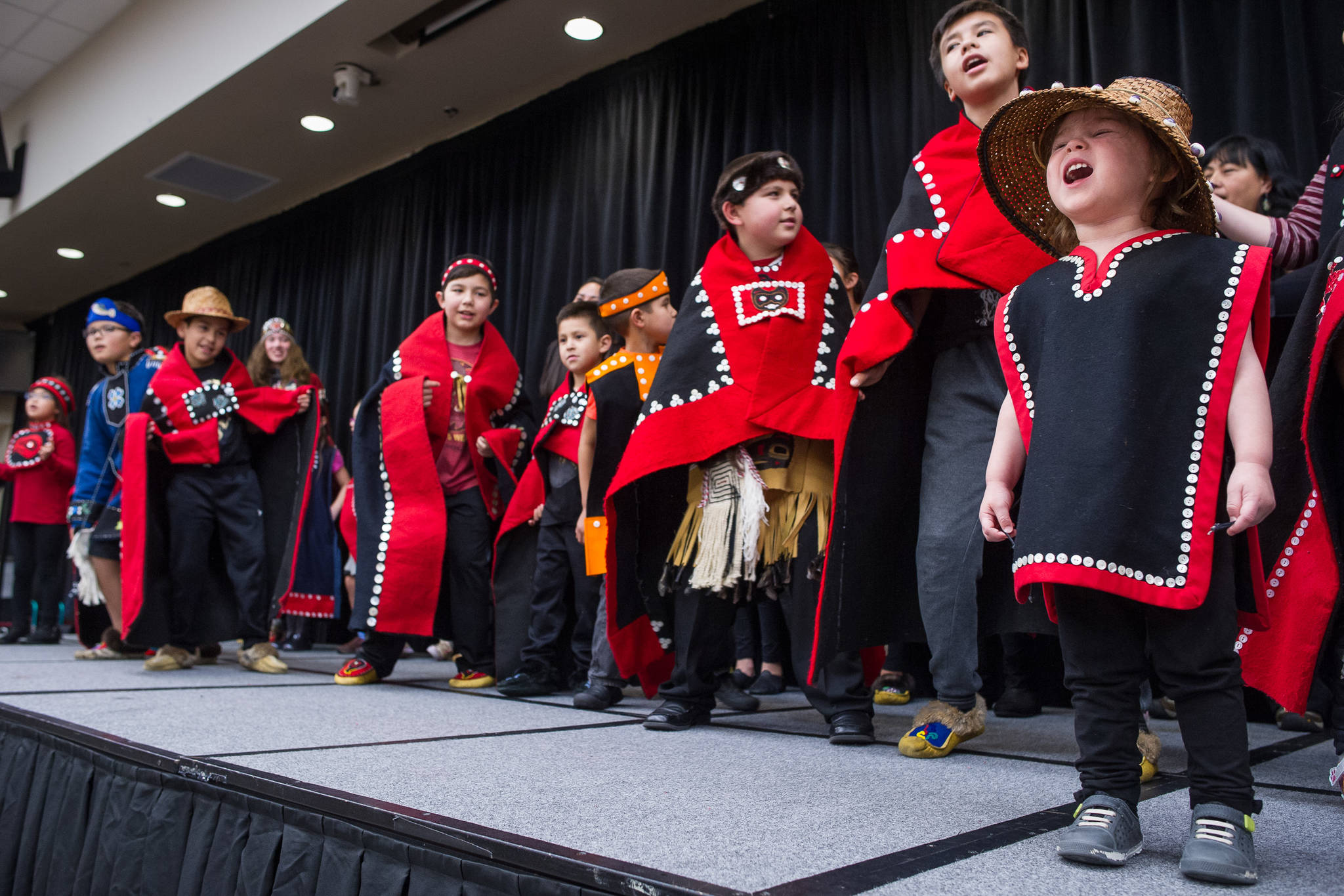 Natalie Soto, 2, helps sing with the All Nations Children Dancers as Juneau residents celebrate Indigenous Peoples Day at Elizabeth Peratrovich Hall on Monday, Oct. 9, 2017. (Michael Penn | Juneau Empire)