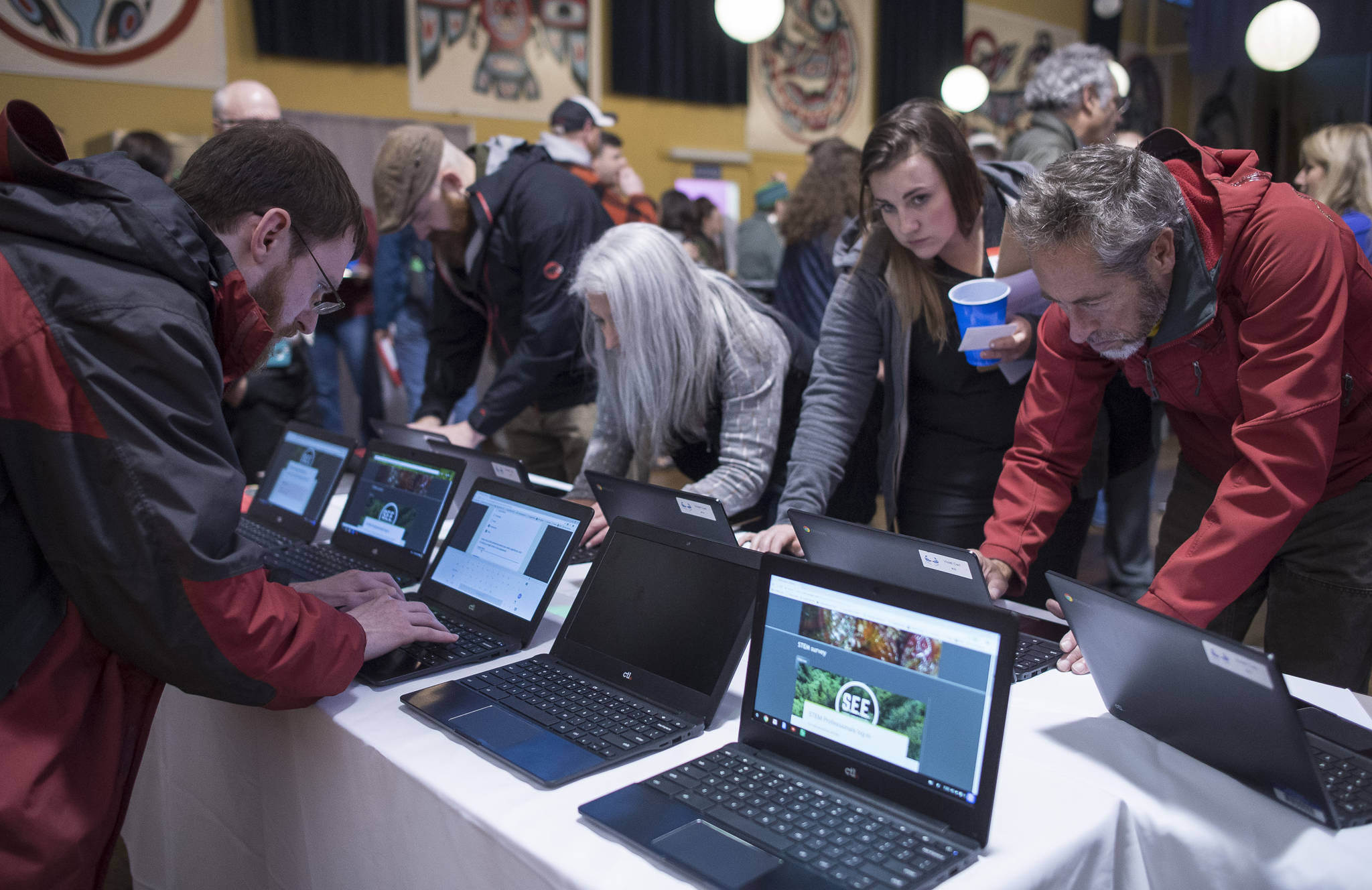 Juneau residents fill out a computer survey during a networking event for teachers and STEM community members at the Juneau Arts and Culture Center on Tuesday, Oct. 17, 2017. The SouthEast Exchange is a new collaboration started by scientists and school teachers, in conjunction with the Juneau STEM Coalition and JEDC. Its broad mission is to share ideas, experience and knowledge within our community and, particularly, to facilitate connections among professionals and teachers to enrich education for Juneau students. (Michael Penn | Juneau Empire)