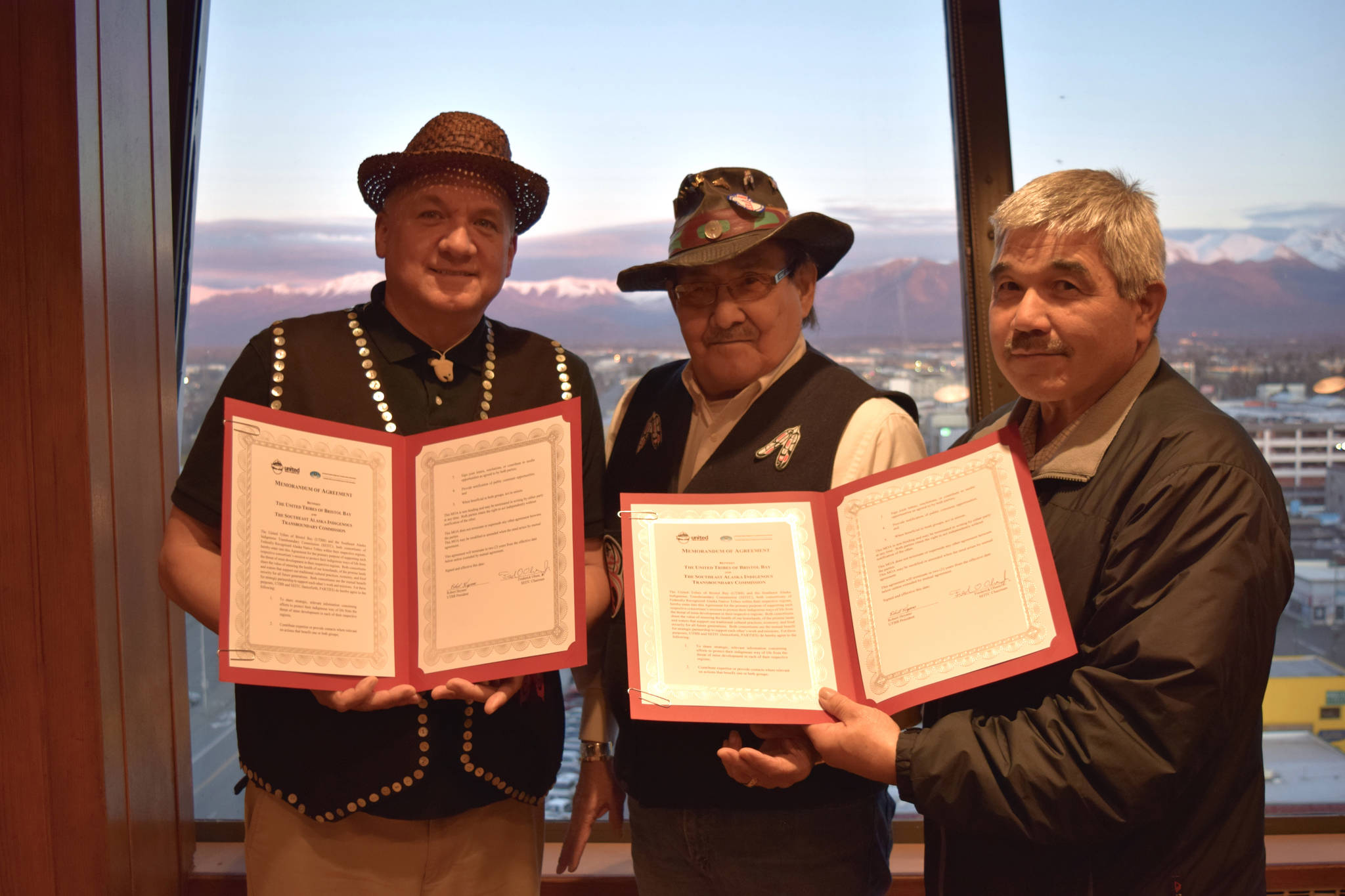 Southeast Alaska Indigenous Transboundary Commission (SEITC) Chariman Frederick Olsen Jr., SEITC Secretary John Morris and United Tribes of Bristol Bay President Robert Heyano show the Memorandum of Agreement uniting the two groups in their efforts to oppose mining projects on salmon watersheds. (Courtesy Photo | Molly Dischner)