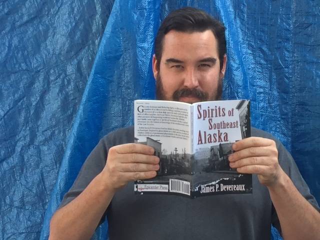 James P. Devereaux poses with his book “Spirits of Southeast Alaska.” Image courtesy of Devereaux.