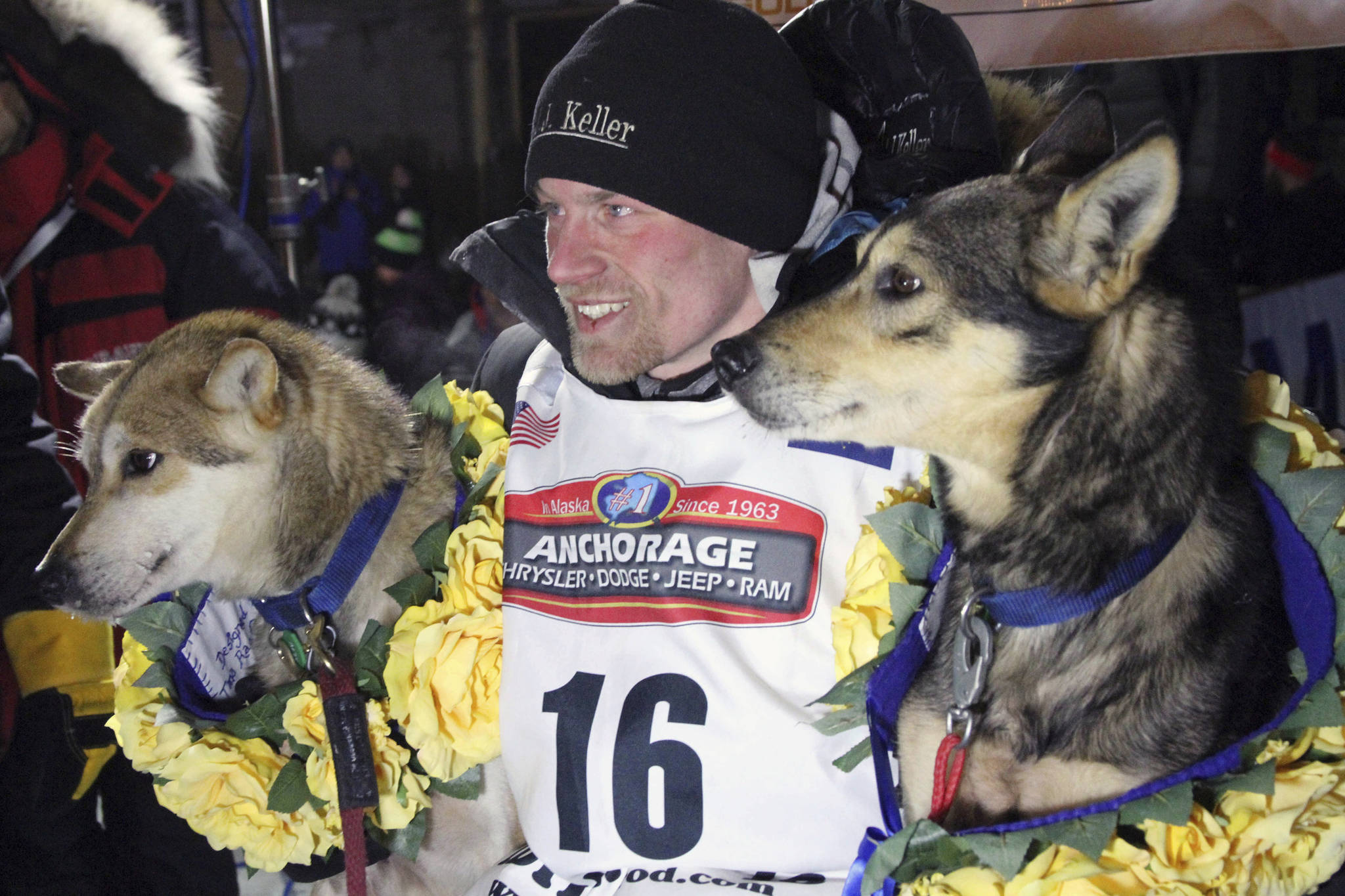 In this March 15, 2016 photo, Dallas Seavey poses with his lead dogs Reef, left, and Tide after finishing the Iditarod Trail Sled Dog Race in Nome. Seavey won his third straight Iditarod, for his fourth overall title in the last five years. Four-time Iditarod champion Dallas Seavey denies he administered banned drugs to his dogs in this year&rsquo;s race, and has withdrawn from the 2018 race in protest. The Iditarod Trail Committee on Monday identified Seavey as the musher who had four dogs test positive for a banned opioid pain reliever after finishing the race last March in Nome. (Mark Thiessen | The Associated Press File)