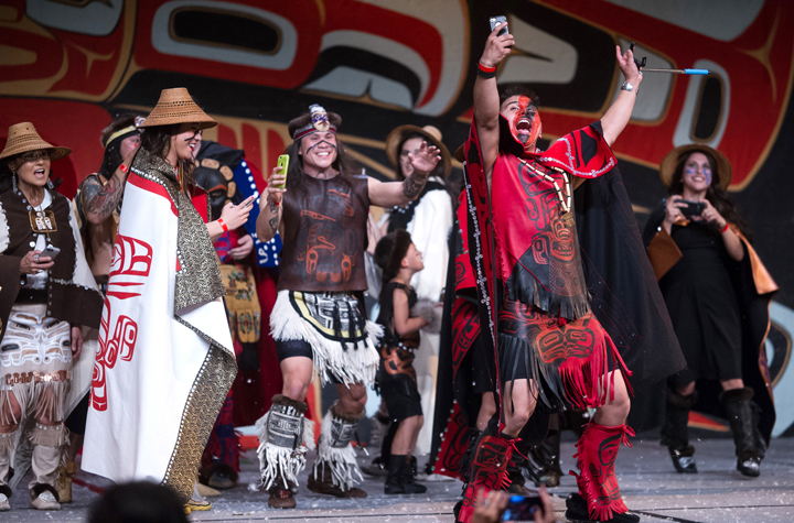 The Git-Hoan Dancers of Metlakatla give their take on snapping selfies during a performance for Celebration 2016 at Centennial Hall. (Michael Penn | Juneau Empire File)