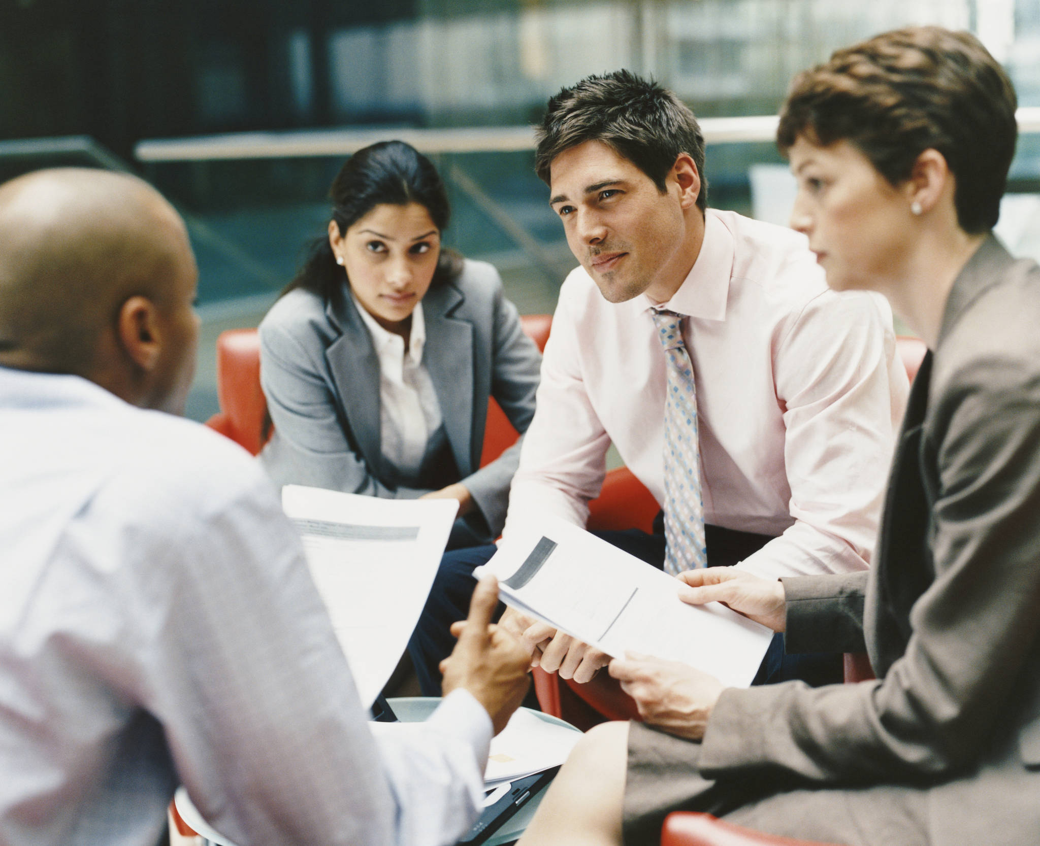 Business people gather for a meeting. (Photo courtesy of Thinkstock)