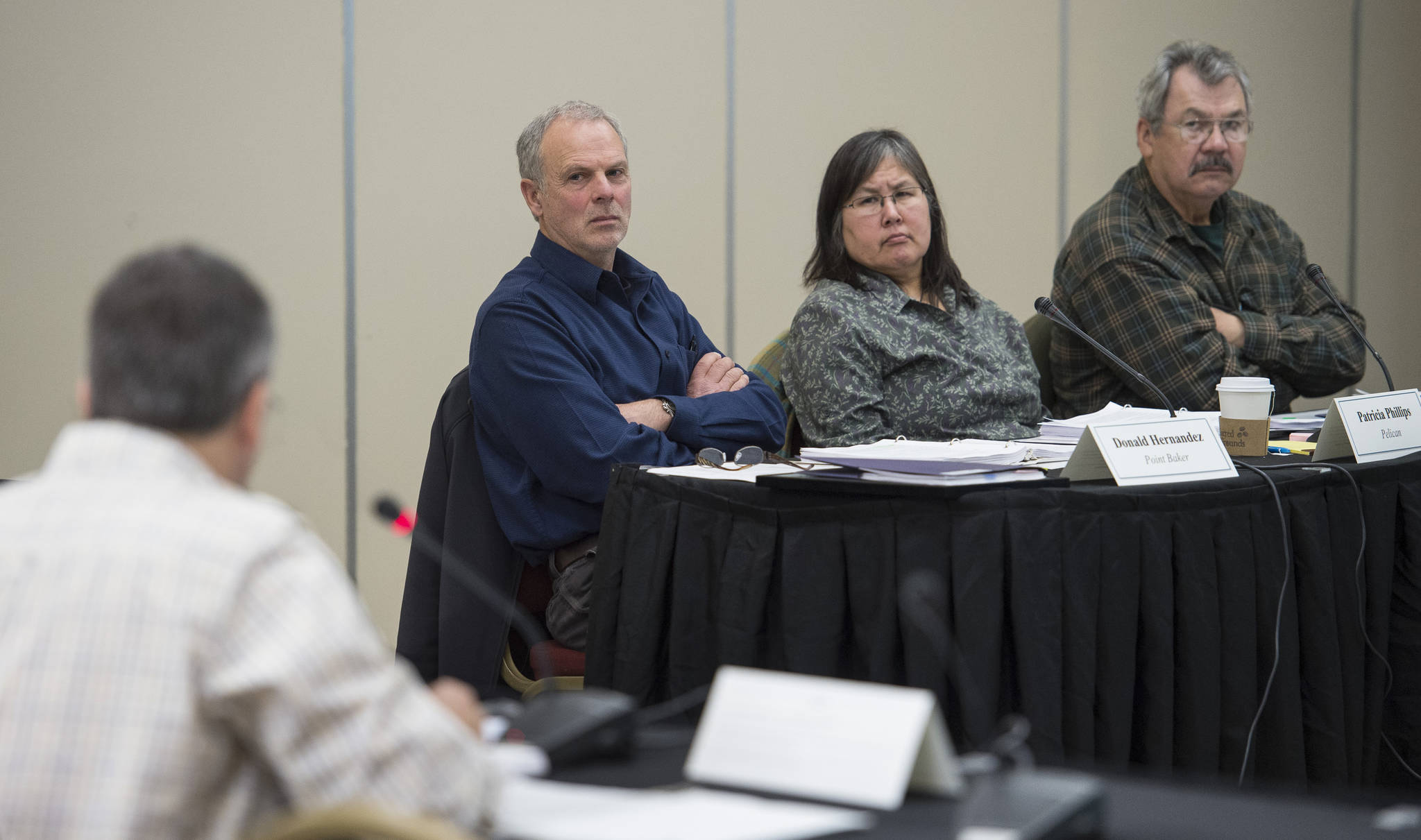 Donald Hernandez, center, of Point Baker, Patricia Phillips, of Pelican, and Michael Douville, of Craig, right, listen to Terry Suminski, with the U.S. Forest Service in Sitka, as the Southeast Alaska Subsistence Regional Advisory Council holds its meeting in Elizabeth Peratrovich Hall on Wednesday, Nov. 1, 2017. (Michael Penn | Juneau Empire)