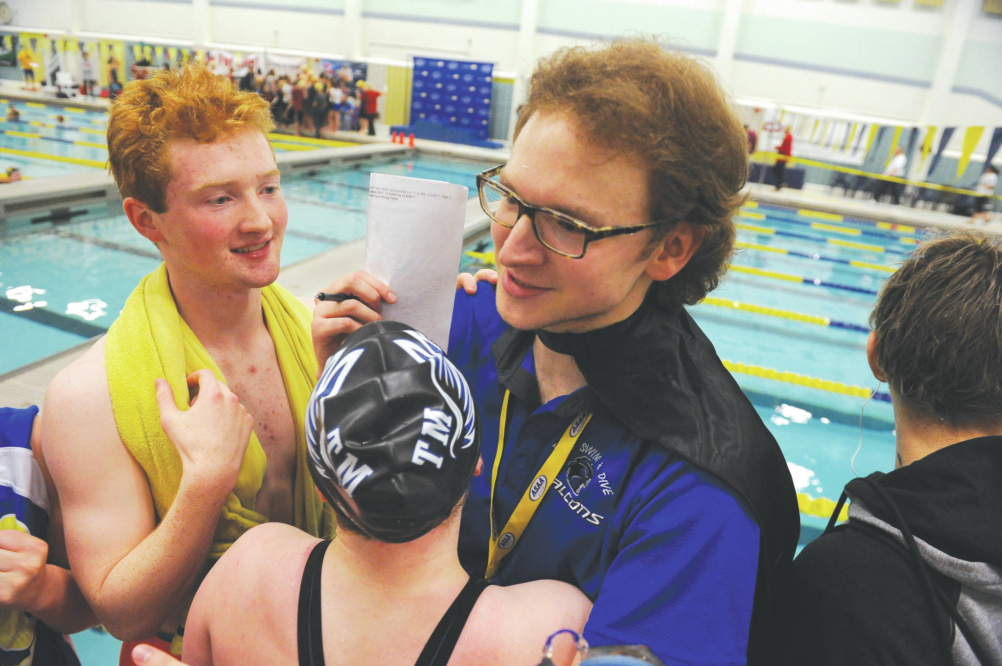 Thunder Mountain High School swim and dive head coach Josiah Loseby is congratulated by his team after the boys won first in the ASAA/First National Bank Alaska State Swim and Dive Championships on Saturday, Nov. 4. (Michael Dinneen | For the Juneau Empire)