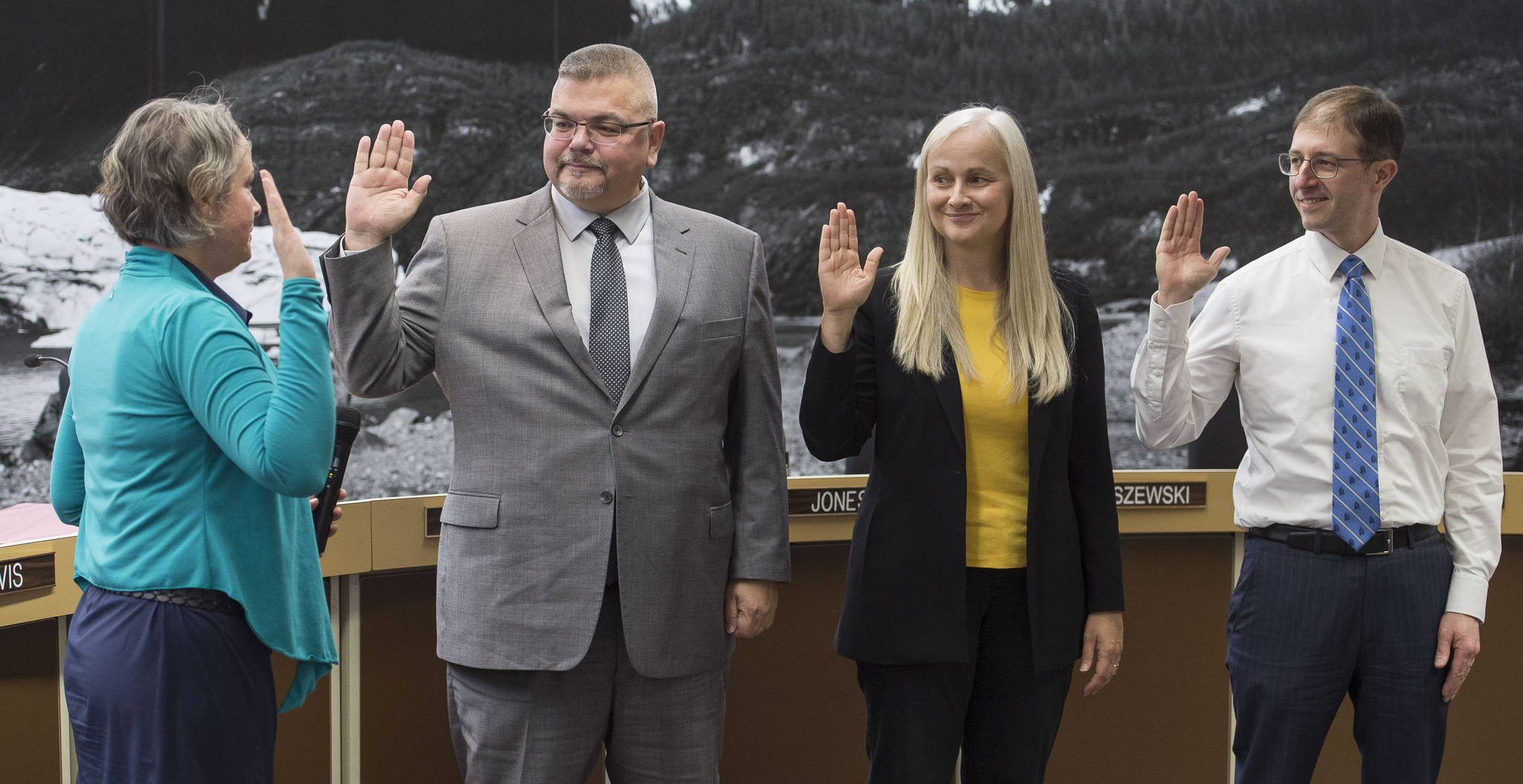 Municipal Attorney Amy Mead, left, swears-in new member Rob Edwardson and returning members Maria Gladziszewski and Jess Kiehl, right, at the Juneau Assembly meeting on Monday, Oct. 16, 2017. At the Monday, Nov. 6 Assembly meeting, Edwardson asked the Assembly to direct Mead to write up an ordinance that would restore the full senior sales tax exemption. The motion failed, but Assembly members said they would talk about the issue later on. (Michael Penn | Juneau Empire)