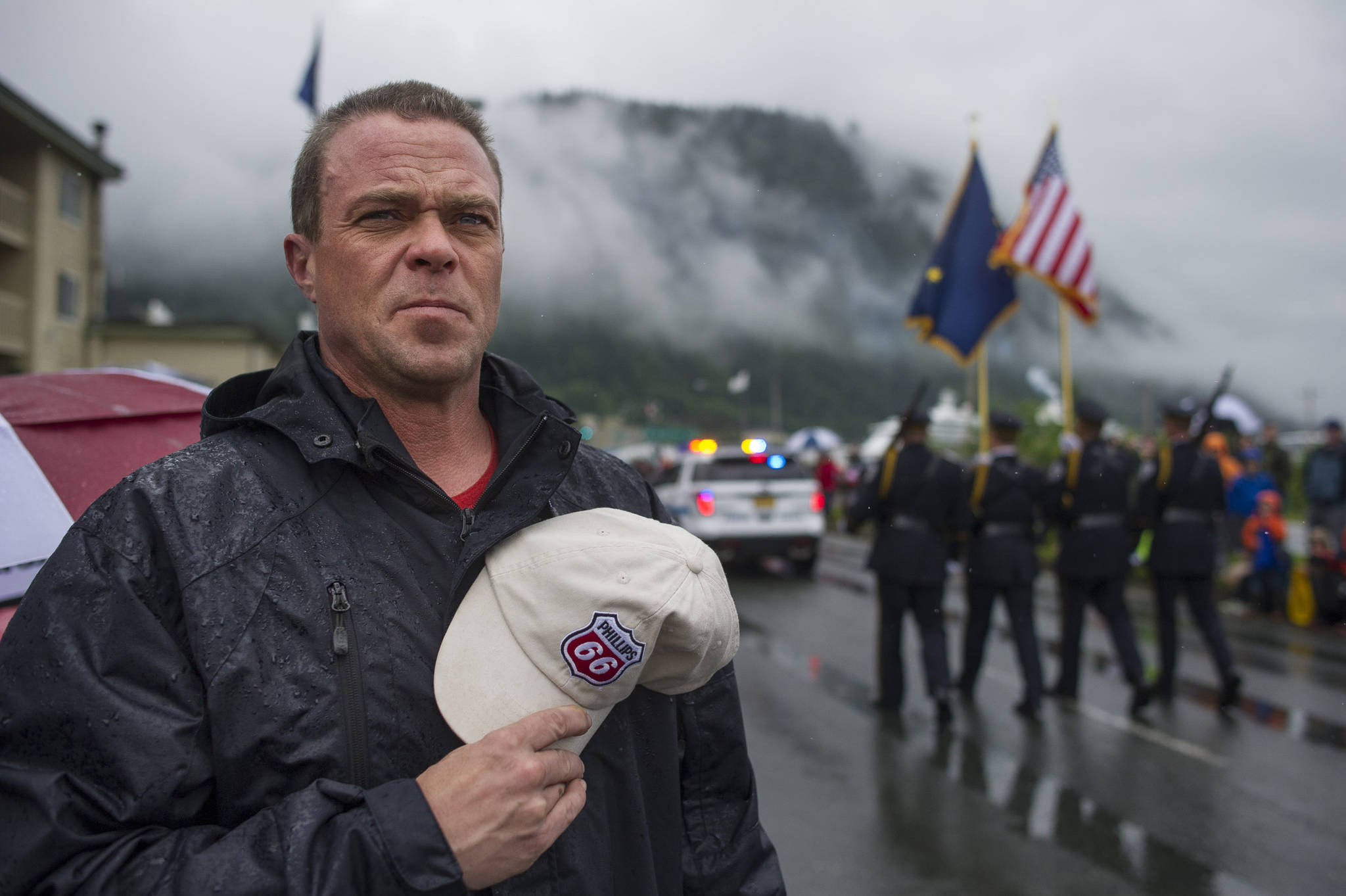 John Grama takes his hat off as a float of veterans nears during the Juneau 4th of July parade on Tuesday, July 4, 2017. (Michael Penn | Juneau Empire)
