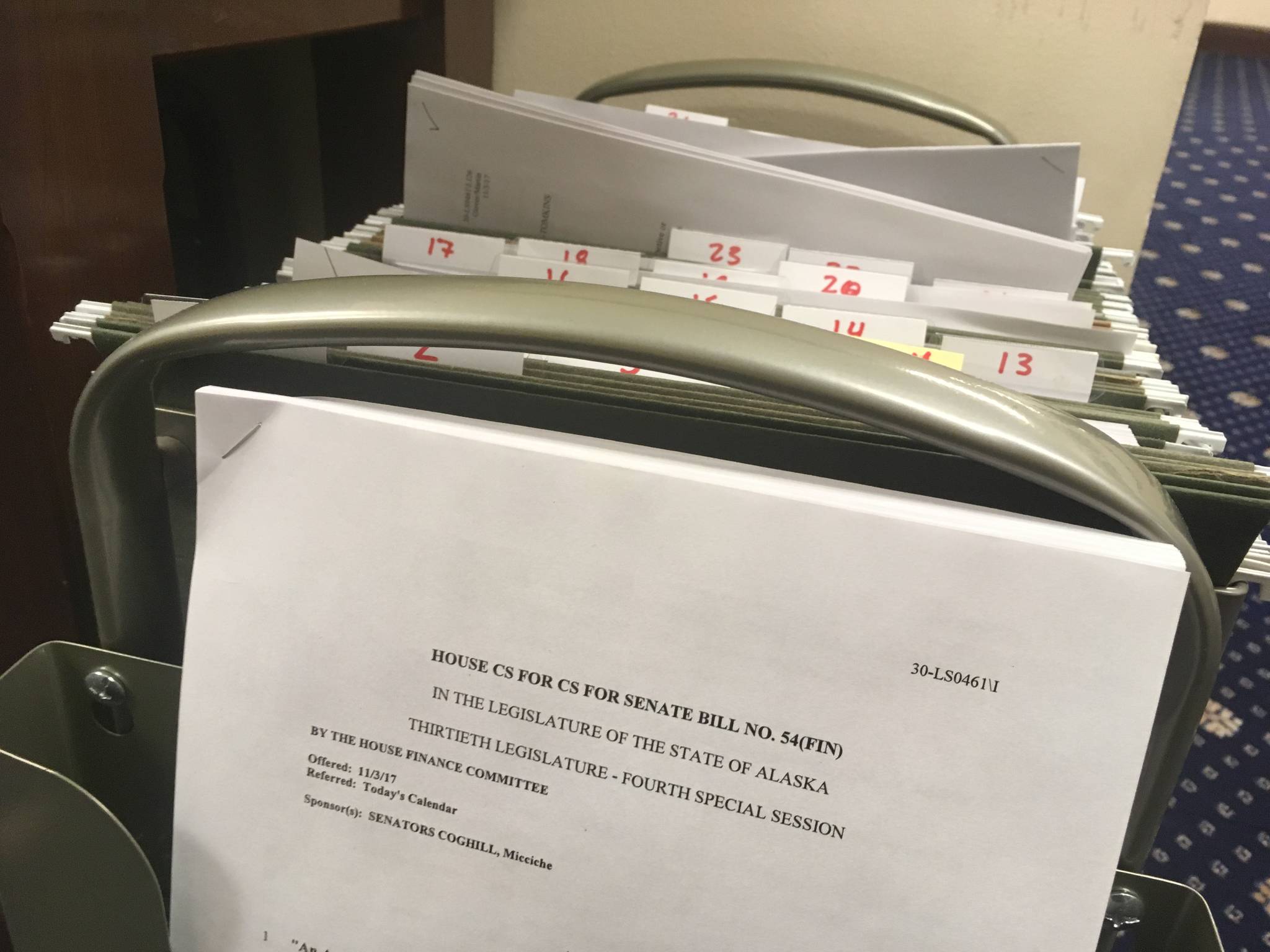 A file cart is seen packed with amendments outside the House Chambers on Wednesday, Nov. 8, 2017 in the Alaska State Capitol. (James Brooks | Juneau Empire)