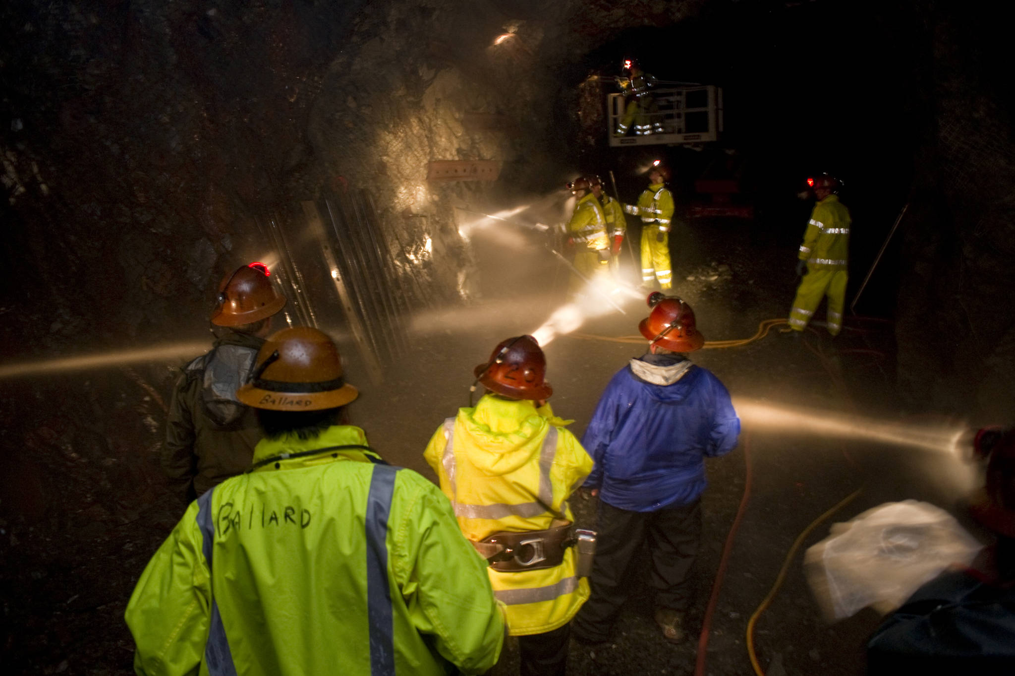 Employees of the Alaska Department of Labor and Workforce Development watch mining students in the Entry Level Underground Mining Training program learn how to hand drill in the AJ Mine in June 2010. (Michael Penn | Juneau Empire)