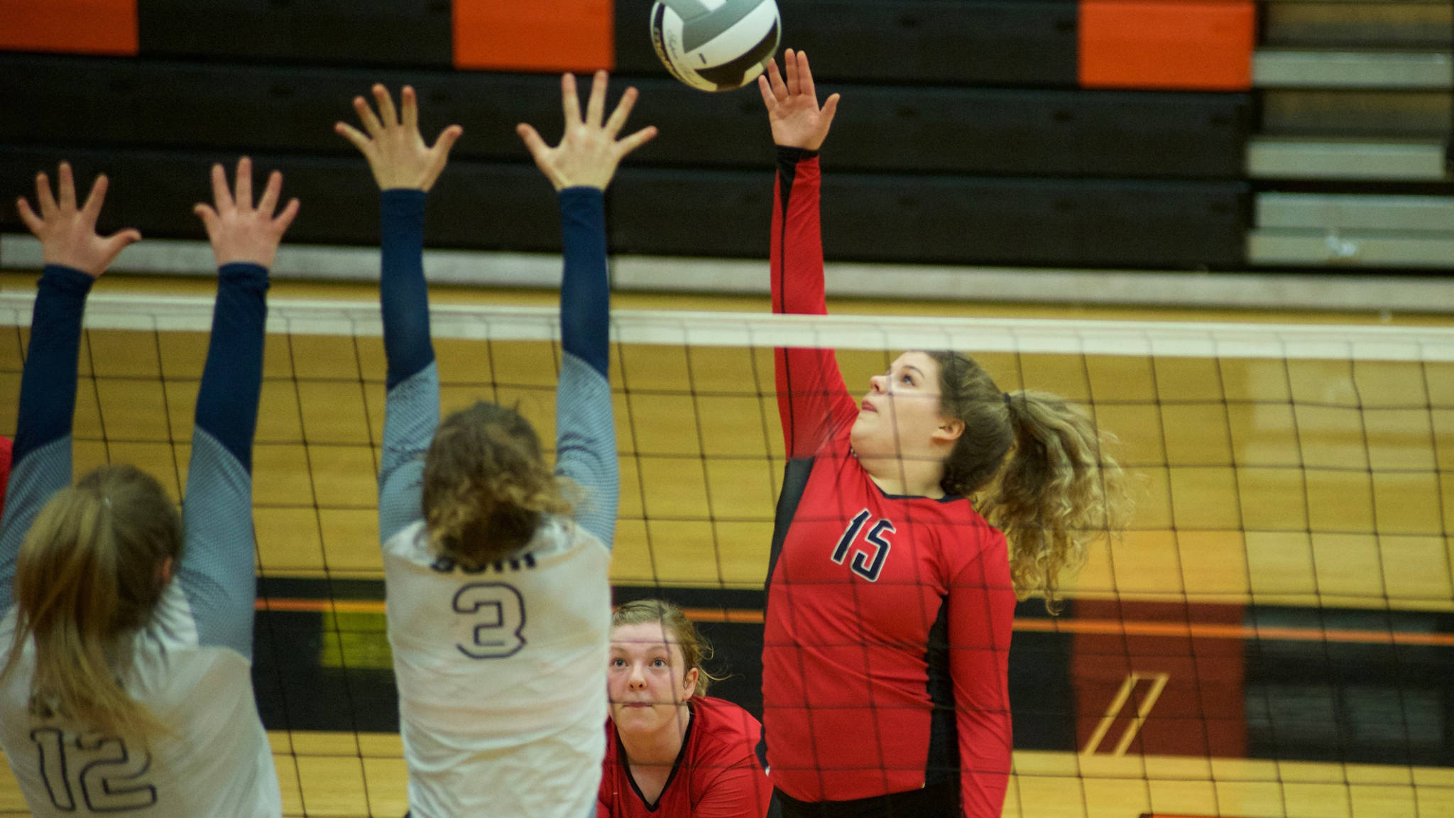 Juneau-Douglas High School junior outside hitter Skylar Hickok hits the ball as Soldotna&rsquo;s Ella Stenga, left, and Bailey Leach go up for a block, Thursday, Nov. 9, during the ASAA/First National Bank Alaska 4A State Volleyball Championships. Soldotna defeated JDHS 3-0. (Nolin Ainsworth | Juneau Empire)