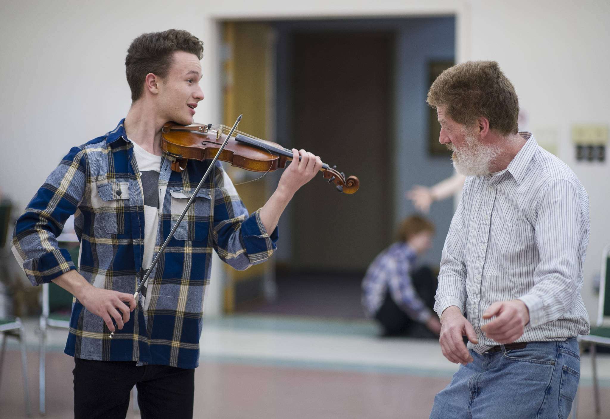Solomon Unzicker as the Fiddler of the Roof with Michael Wittig as Tevye at the tehearsal of Latitude 58’s production of “Fiddler on the Roof” at St. Ann’s Hall on Thursday, Nov. 9, 2017. (Michael Penn | Capital City Weekly)