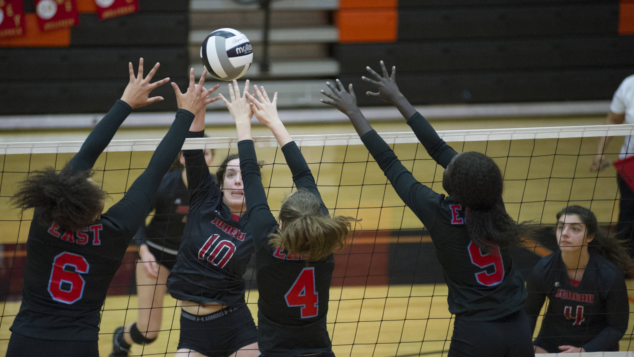 East Anchorage&rsquo;s Daisy Page (6), Riley Ostrinski (4) and Nyanuer Bidit (9) swarm Juneau-Douglas High School senior middle hitter Jessica Pierce as she sends the ball over the net, Friday, Nov. 10, 2017, at the ASAA/First National Bank Alaska 4A State Volleyball Championships. East Anchorage defeated JDHS 3-0 (25-17, 25-16, 25-20) to eliminate them from the tournament, played at West Anchorage High School Nov. 9-11. (Nolin Ainsworth | Juneau Empire)