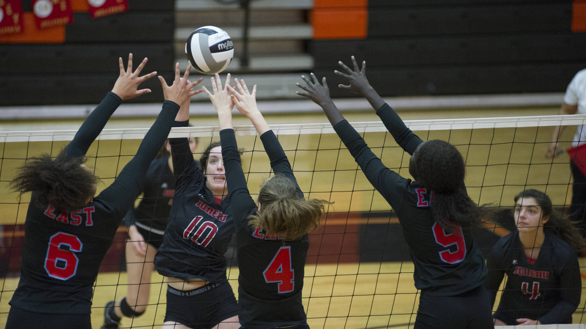 East Anchorage’s Daisy Page (6), Riley Ostrinski (4) and Nyanuer Bidit (9) swarm Juneau-Douglas High School senior middle hitter Jessica Pierce as she sends the ball over the net, Friday, Nov. 10, 2017, at the ASAA/First National Bank Alaska 4A State Volleyball Championships. East Anchorage defeated JDHS 3-0 (25-17, 25-16, 25-20) to eliminate them from the tournament, played at West Anchorage High School Nov. 9-11. (Nolin Ainsworth | Juneau Empire)