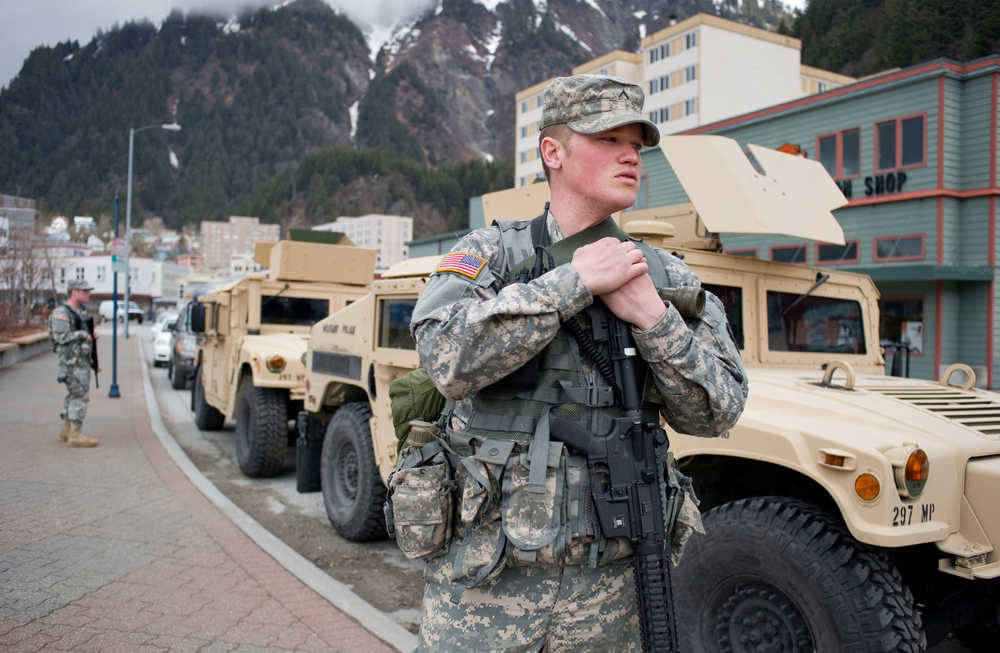 In this April 2011 photo, Private Gabriel Jones of Wasilla, right, and Private Joshua Bollick of Anchorage, stand guard next to three armoured personel carriers belonging to the Alaska Army National Guard 297th Military Police Company as they practice in downtown Juneau. (Juneau Empire File)