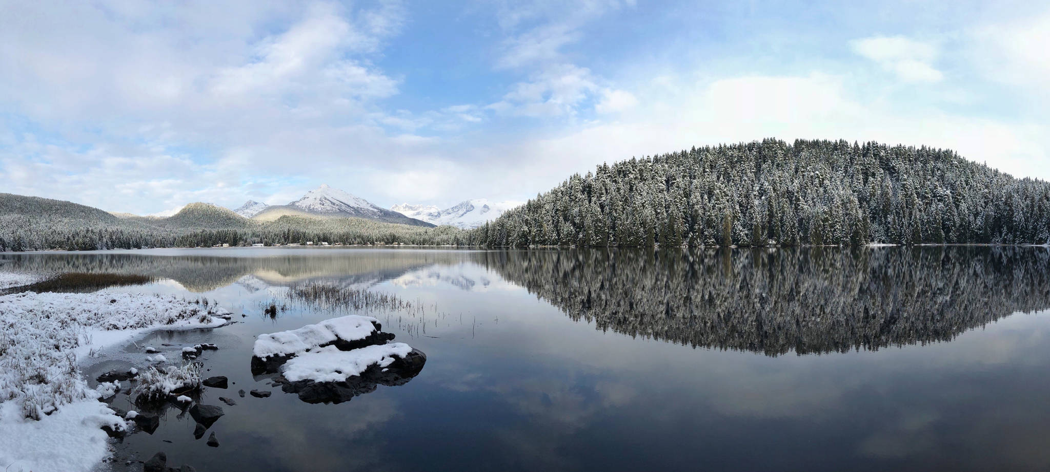 The landscape reflects in Auke Lake on Saturday, Nov. 11, 2017. (Angelo Saggiomo | Juneau Empire)