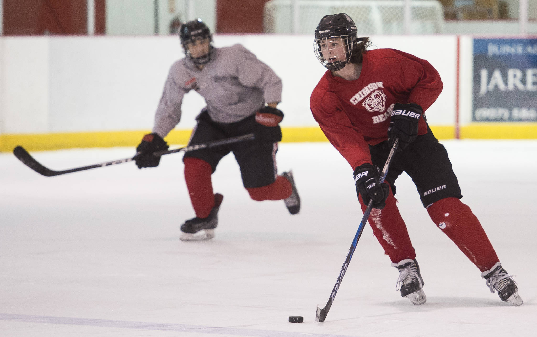Cameron Smith, right, brings the puck up with Joseph Monsef during Juneau-Douglas High School hockey practice at the Treadwell Arena on Thursday, Nov. 16, 2017. (Michael Penn | Juneau Empire)
