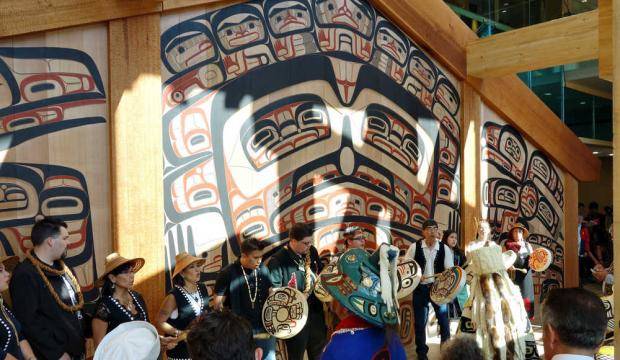 In this file photo from May 2015, Tsimshian carver David A. Boxley, fourth from right in line of drummers, drums and sings in front of the clan house screen he created for the Walter Soboleff Building in Juneau during the screen’s dedication ceremony. (Michael Penn | Juneau Empire File)