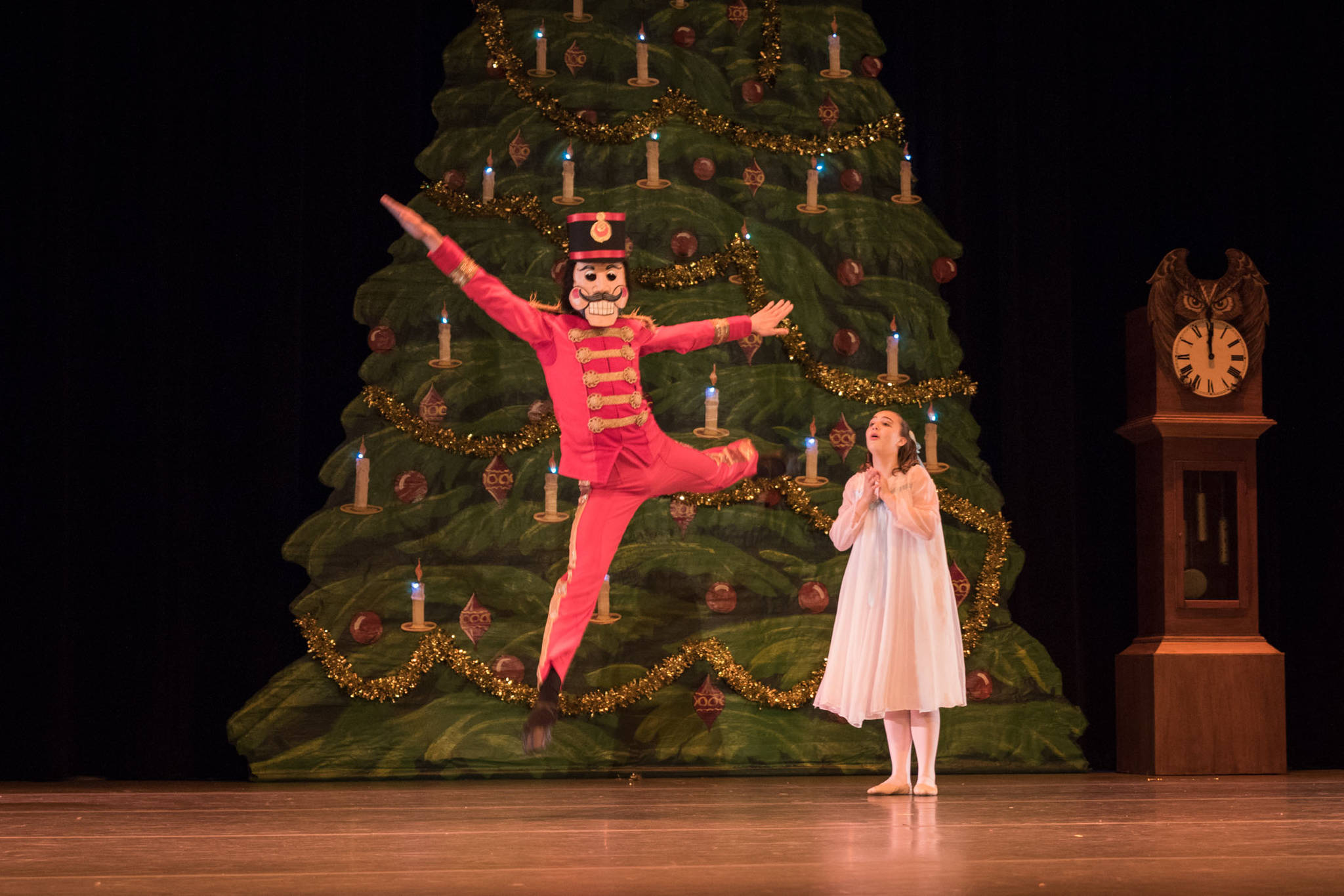The Nutcracker, played by Kincaid Parsons, leaps across the stage as and Marie, played by Grace Gjertsen, looks on. Photo by Bobbi Jordan.