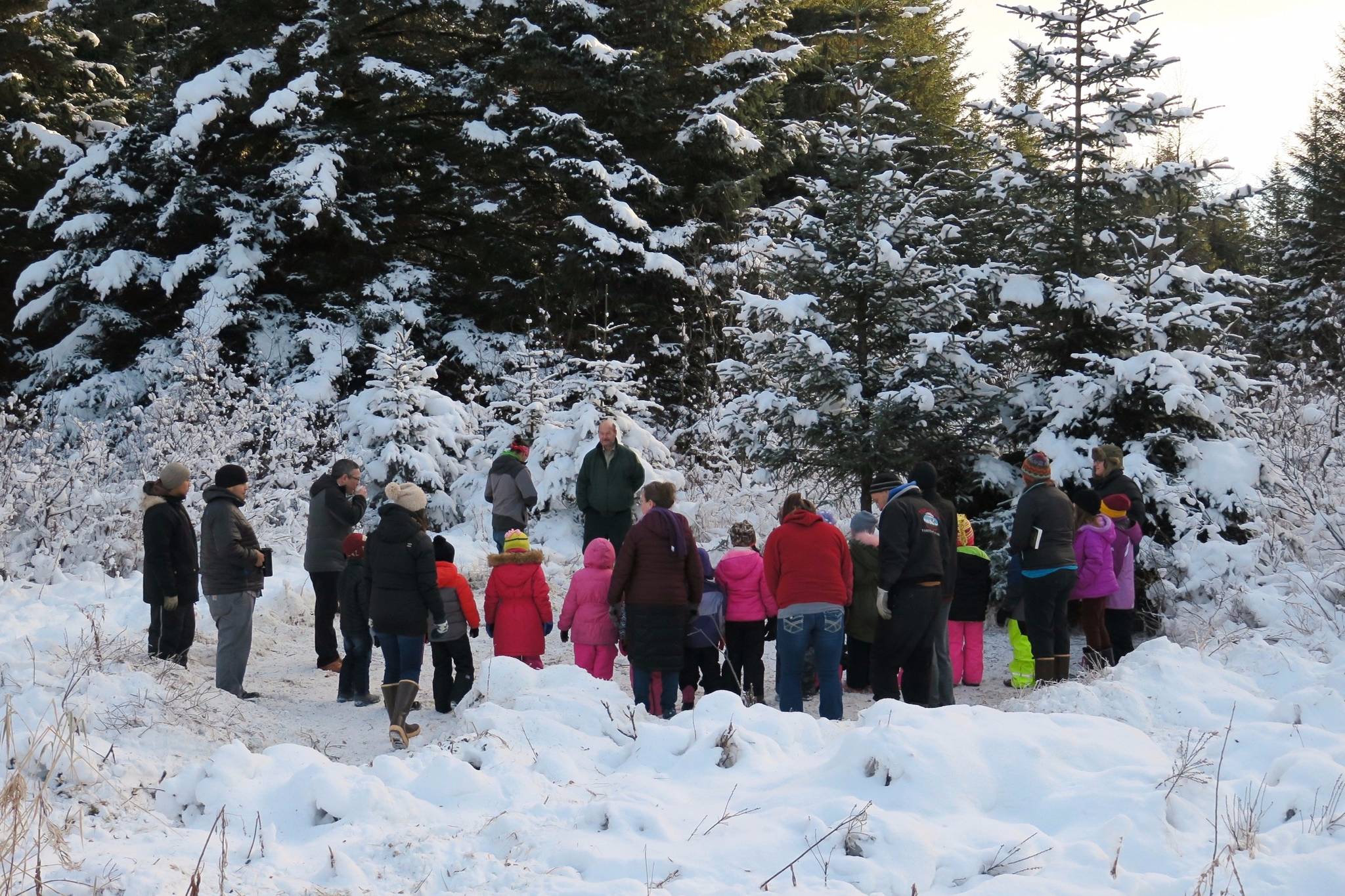 Members of the U.S. Forest Service, Yakutat Tlingit Tribe and Yakutat Schools are seen at the Good Neighbor Tree blessing ceremony Nov. 22 before the tree was harvested and sent to Juneau that evening. (Courtesy Photo | Russel Wicka via the U.S. Forest Service)