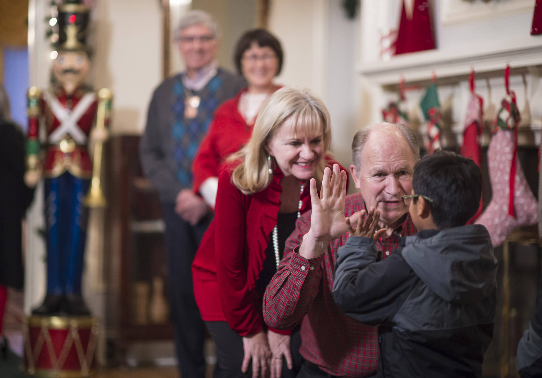 Gov. Bill Walker and his wife, Donna, gets a greeting from Henry Olmstead as he arrives for the Governor’s Open House on Tuesday, Dec. 5, 2017. Lt. Gov. Byron Mallott and his wife, Toni, were also there for the annual opening. (Michael Penn | Juneau Empire)