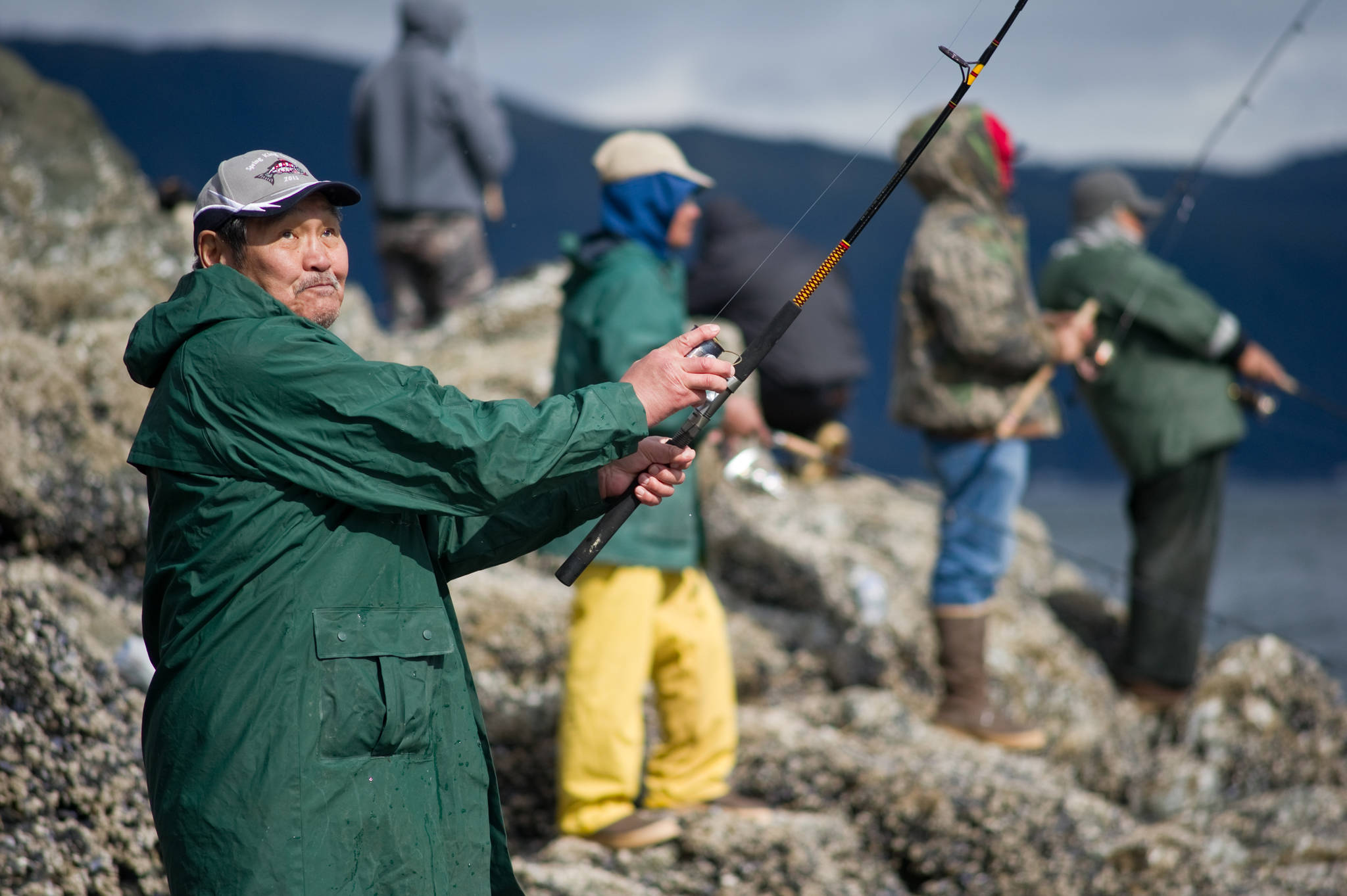 In this 2014 photo, Percy Douglas casts his line for king salmon off the rocks at False Outer Point. (Michael Penn | Juneau Empire)