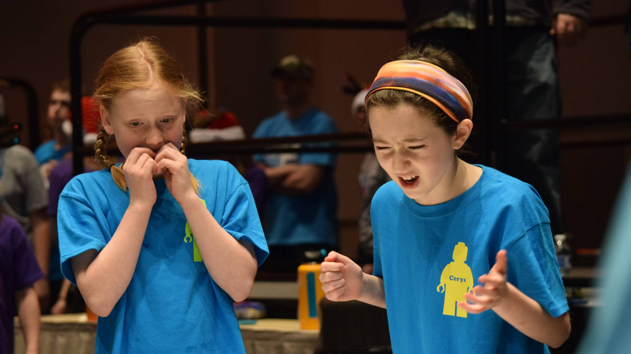 Two competitors in the Juneau Robot Jamboree react to an uncooperative robot at Centennial Hall Convention Center on Saturday. (Kevin Gullufsen | Juneau Empire)