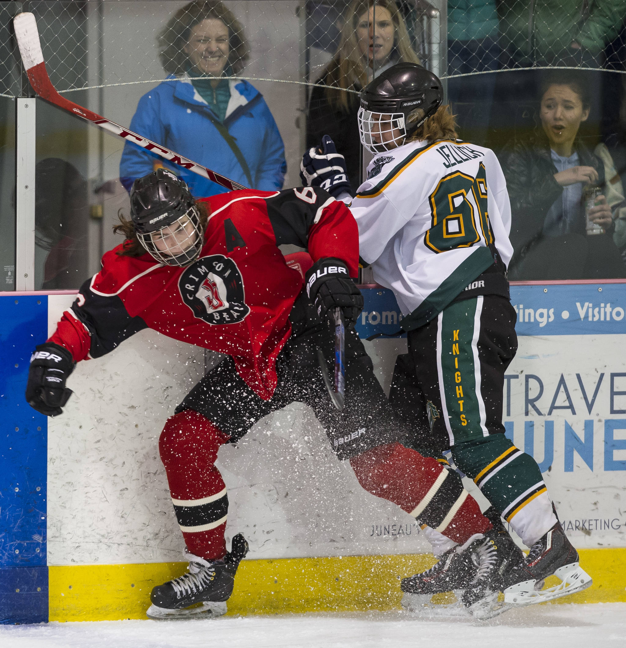 Juneau-Douglas&rsquo; Cameron Smith, left, is checked by Colony&rsquo;s Dane Jellich at Treadwell Arena on Friday, Dec. 15, 2017. Colony won 6-1. (Michael Penn | Juneau Empire)