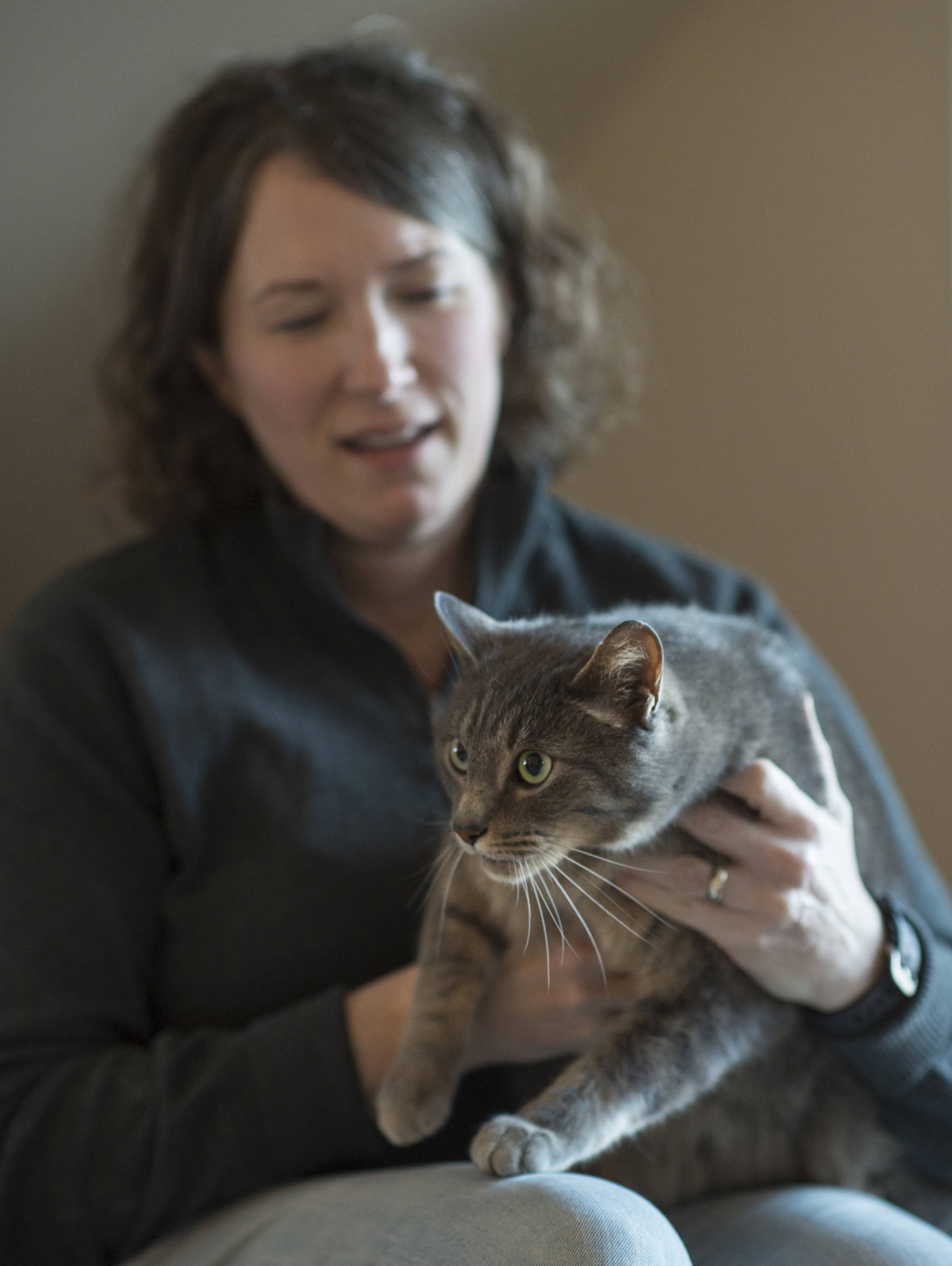Teresa Bleakley holds her 3-year-old cat Percy at her valley home on Tuesday, Dec. 19, 2017. Percy was found after being lost for nine months. (Michael Penn | Juneau Empire)