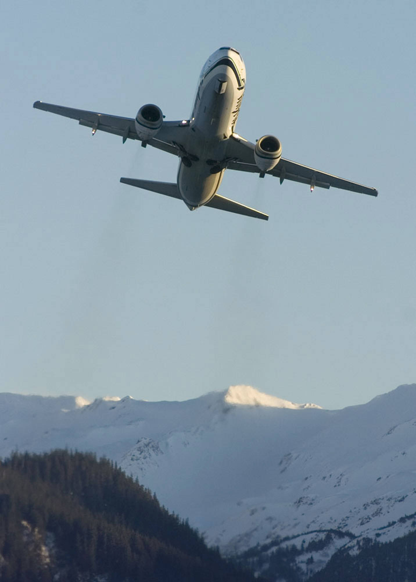 A passenger jet lifts off from the Juneau International Airport. (Michael Penn | Juneau Empire File)