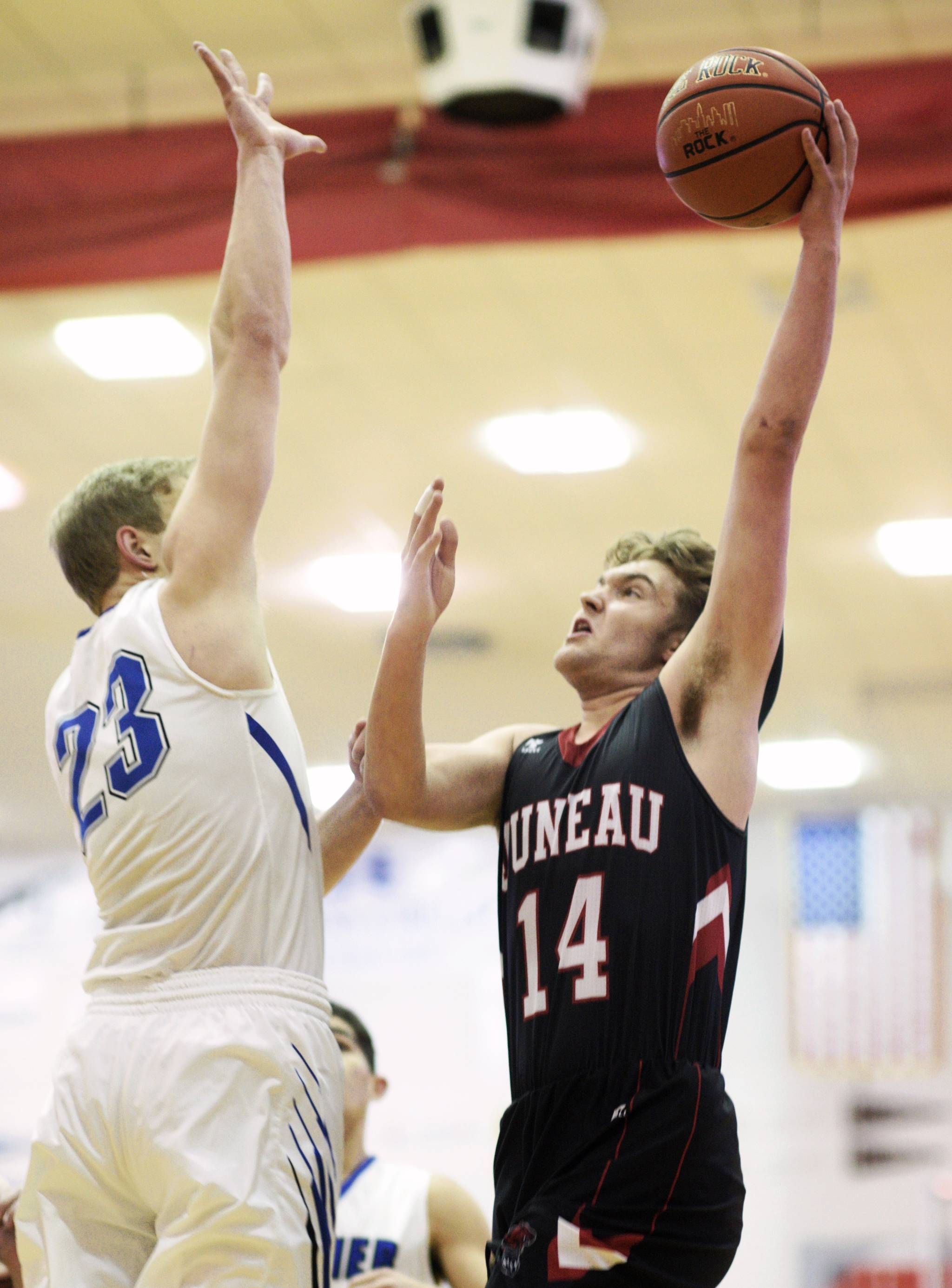 Juneau-Douglas’ Kasey Watts drives to the basket against Palmer’s Clayton Southwick during their Capital City Classic game on Saturday, Dec. 30, 2017. (Michael Penn | Juneau Empire)