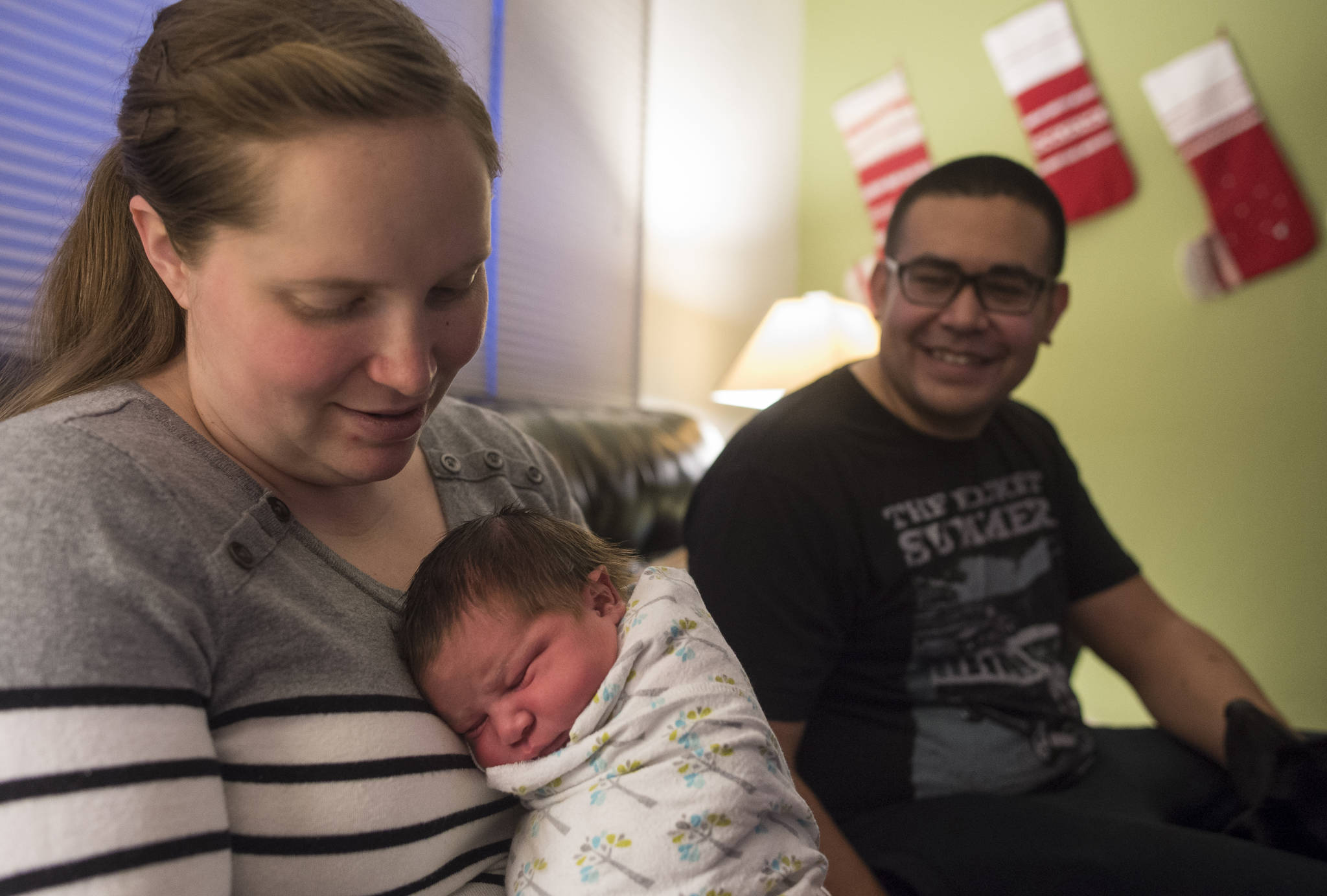 Christine and Dominique Johnson with their new daughter, Adelaide Olivia, at their Mendenhall Valley home on Monday, Jan. 1, 2018. Adelaide was born Monday at 12:27 a.m. at the Juneau Birth Center. (Michael Penn | Juneau Empire)  Christine and Dominique Johnson with their new daughter, Adelaide Olivia, at their Mendenhall Valley home on Monday, Jan. 1, 2018. Adelaide was born Monday at 12:27 a.m. at the Juneau Birth Center. (Michael Penn | Juneau Empire)