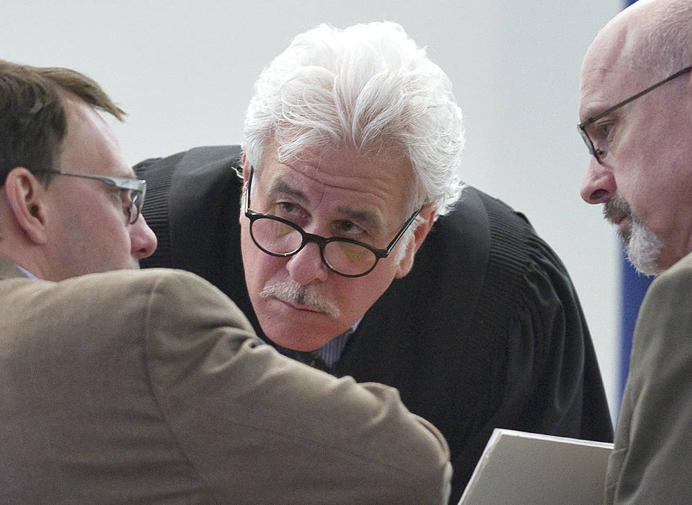 In this file photo from April 2012, Juneau Superior Court Judge Louis Menendez, center, holds a conference with Assistant Public Defender Eric Hedland, left, and then-District Attorney David Brower during a criminal trial. (Michael Penn | Juneau Empire File)
