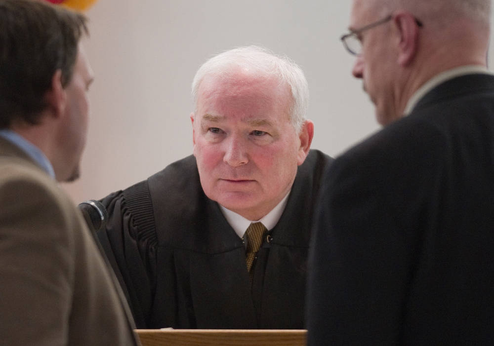 Sitka Superior Court Judge David George confers with public defender Eric Hedland, left, and District Attorney David Brower during a hearing in Oct. 2012. (Michael Penn | Juneau Empire File)