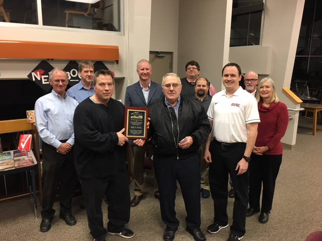 he Board of Education recognizes Phil and Richard Isaak (center) for the generous donation of a digital video scoreboard system in the JDHS gym.
