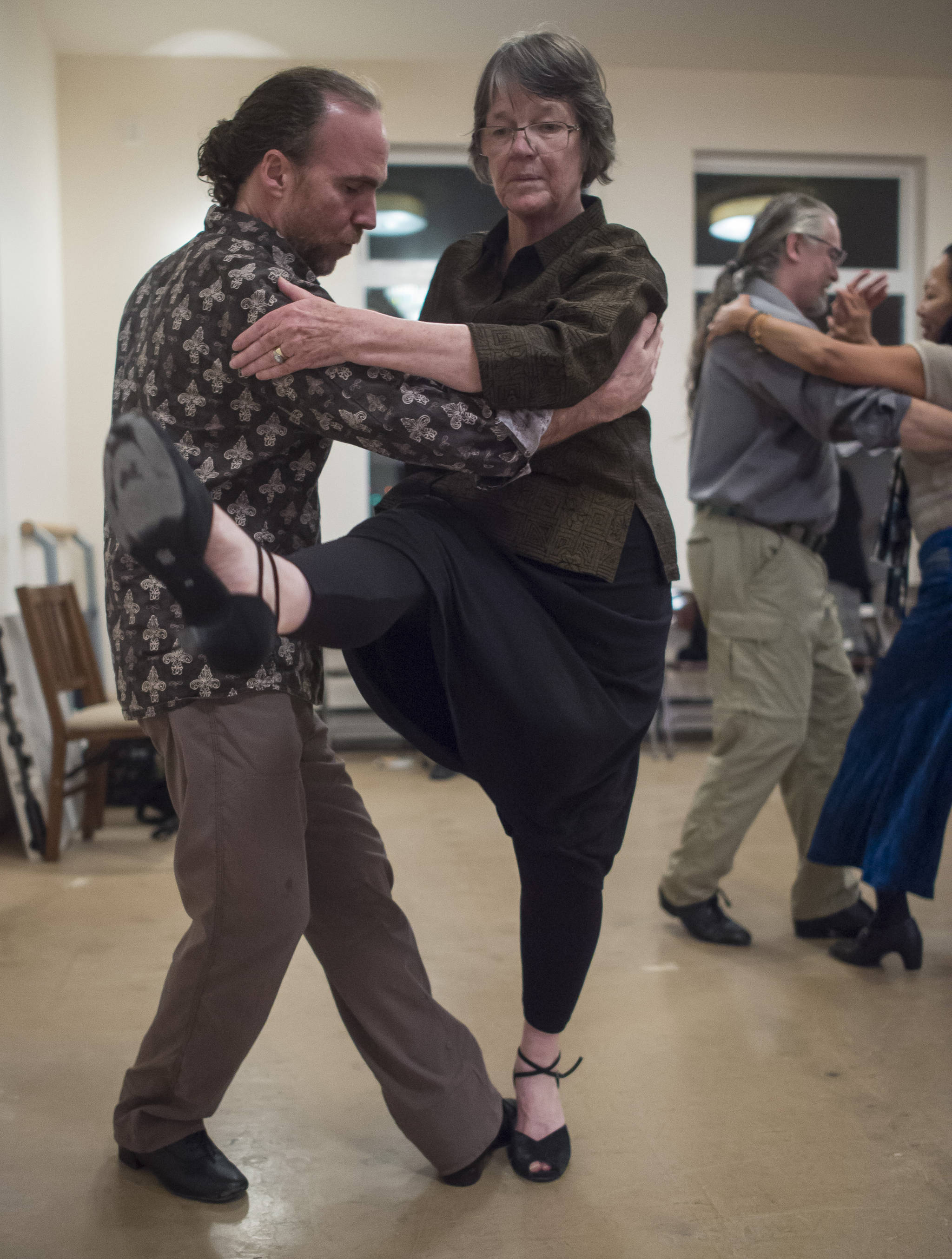 Jane Stokes dances with David Albert at the weekly Tango class at the Channel Dance Studio on Thursday, Jan. 4, 2018. (Michael Penn | Juneau Empire)