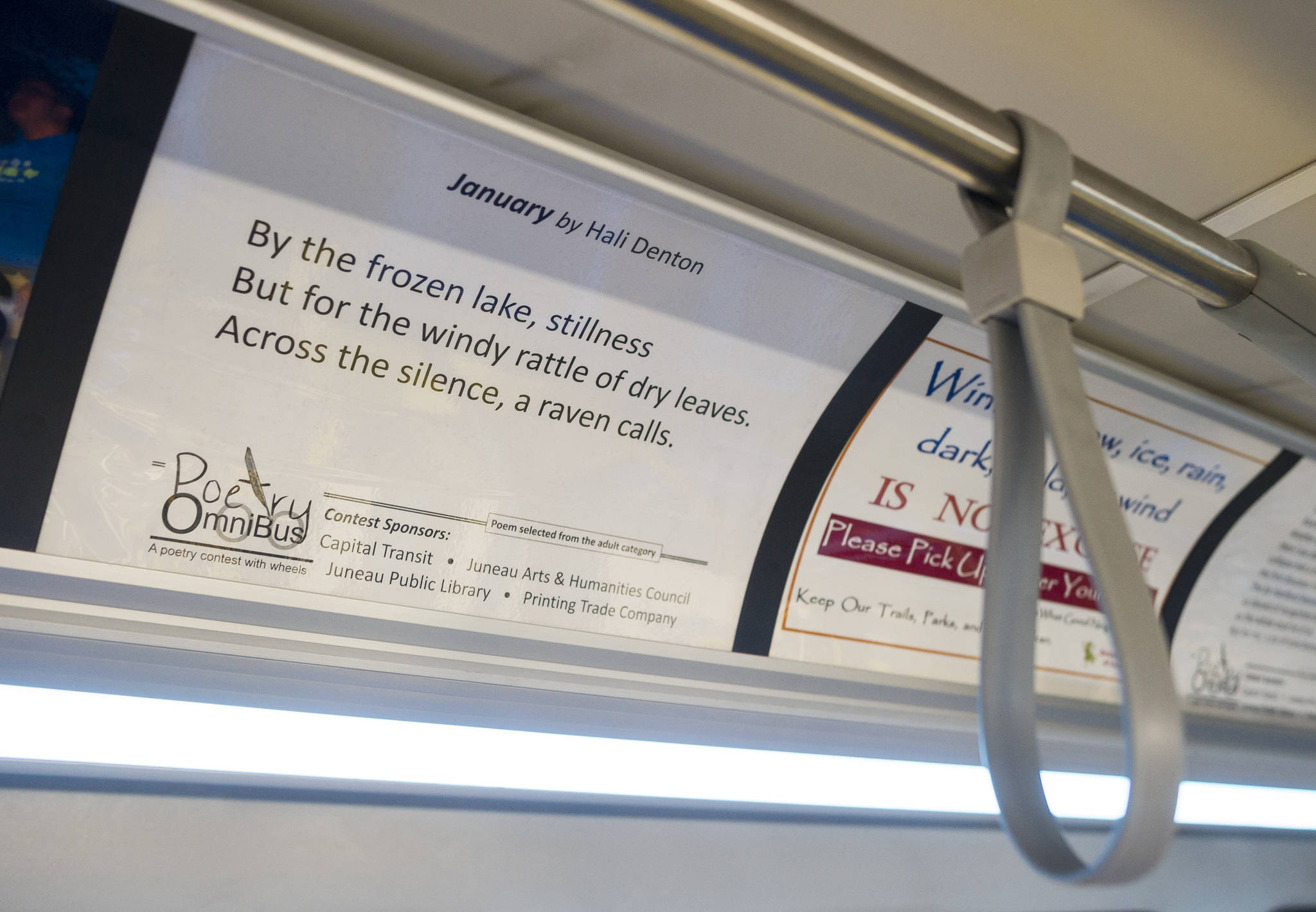 A poem by Hali Denton is displayed on a Capital Transit bus on Thursday, Jan. 4, 2018. Each bus has two selected poem displayed from the annual Poetry OmniBus contest. (Michael Penn | Juneau Empire)