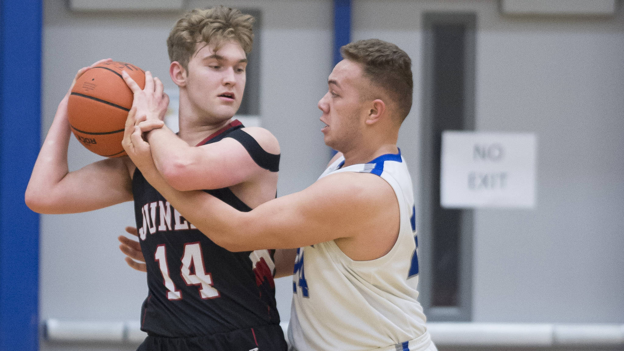 Juneau-Douglas’ Kasey Watts is fouled by Thunder Mountain’s Vaipuna Toutaiolepo during their game at TMHS on Friday, Jan. 5. The Crimson Bears and Falcons both lost on Thursday in the Alaska Prep Shootout and Joe T. Classic, respectively. (Michael Penn | Juneau Empire File)