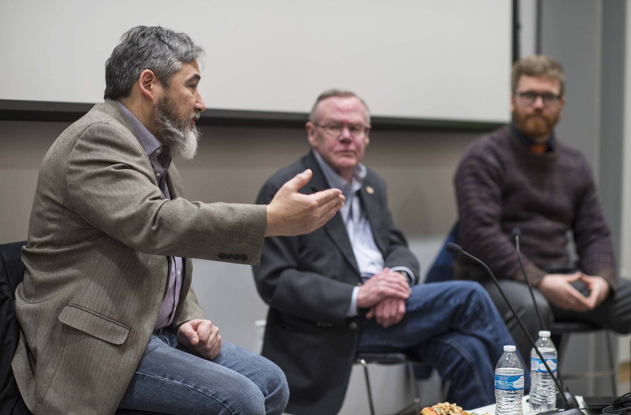 Rep. Sam Kito, D-Juneau, Sen. Dennis Egan, D-Juneau and Rep. Justin Parish, D-Juneau, answer questions from Juneau area residents about legislative priorities during a townhall meeting at the Mendenhall Valley Public Library on Thursday, Jan. 11, 2018. (Michael Penn | Juneau Empire)