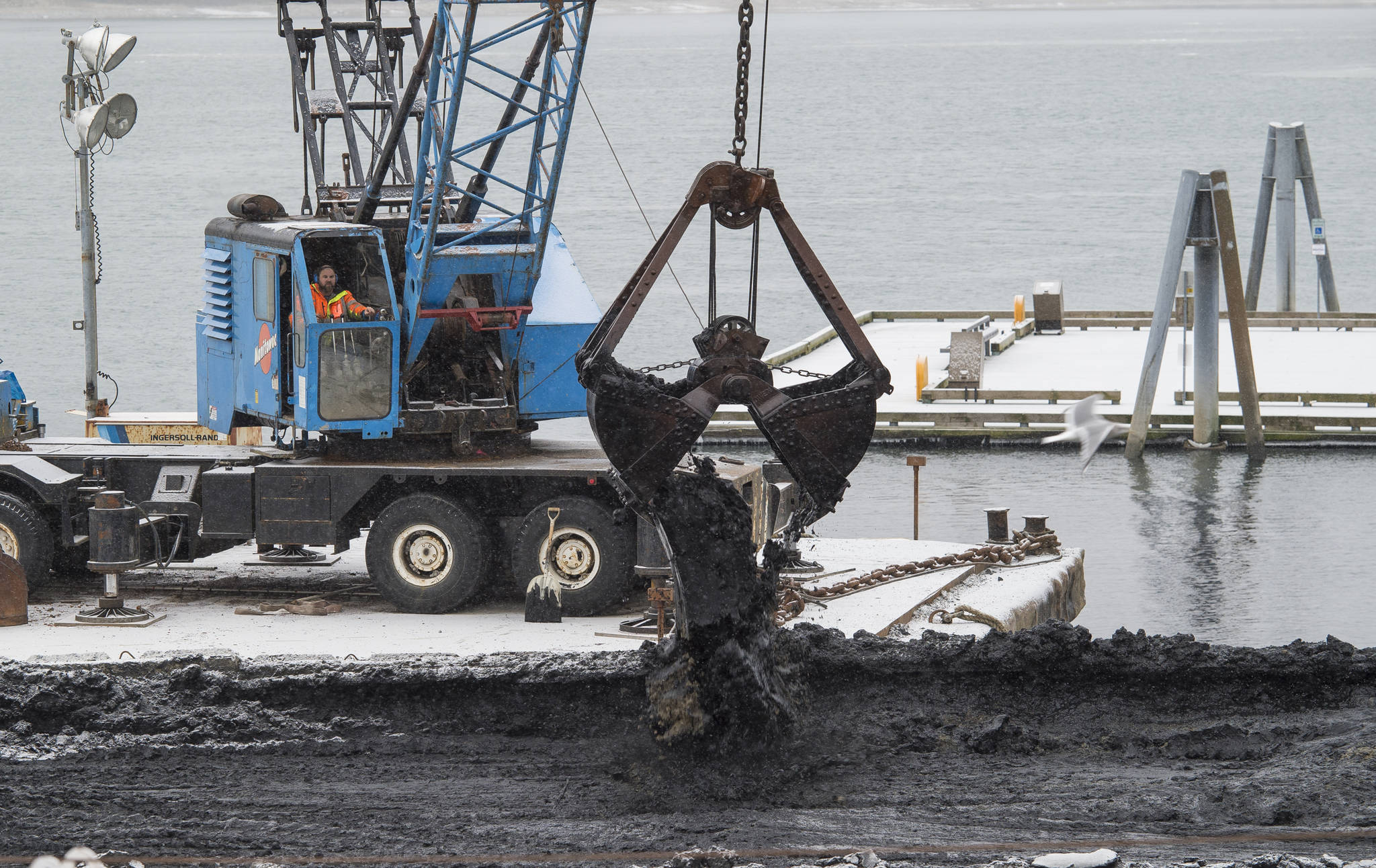 Dredging is taking place as the DIPAC Macaulay Salmon Hatchery on Friday, Jan. 12, 2018, to make room for salmon rearing pens. (Michael Penn | Juneau Empire)