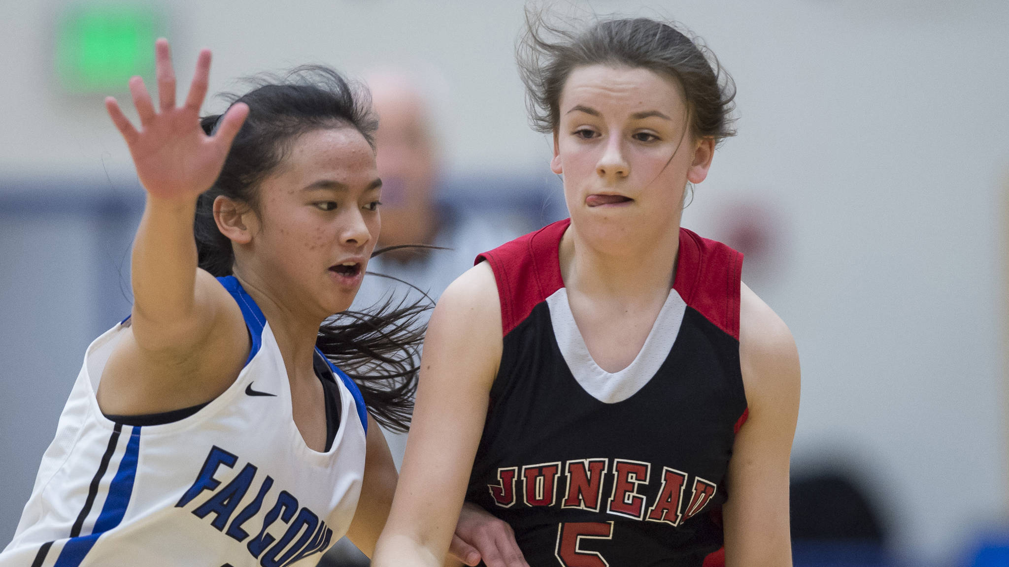 Juneau-Douglas’ Kiana Potter, right, dribbles against Thunder Mountain’s Khaye Garcia during their game at TMHS on Friday, Jan. 5. The JDHS and TMHS girls both lost their games on Friday. (Michael Penn | Juneau Empire File)