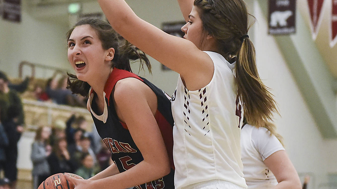 Juneau-Douglas High School freshman Janae Pusich looks for the hoop as Kayhi’s Brittany Slick defends on Friday in Ketchikan. The Crimson Bears lost to the Kayhi Kings 75-62 on Friday and 46-31 on Saturday. (Hall Anderson | Ketchikan Daily News)