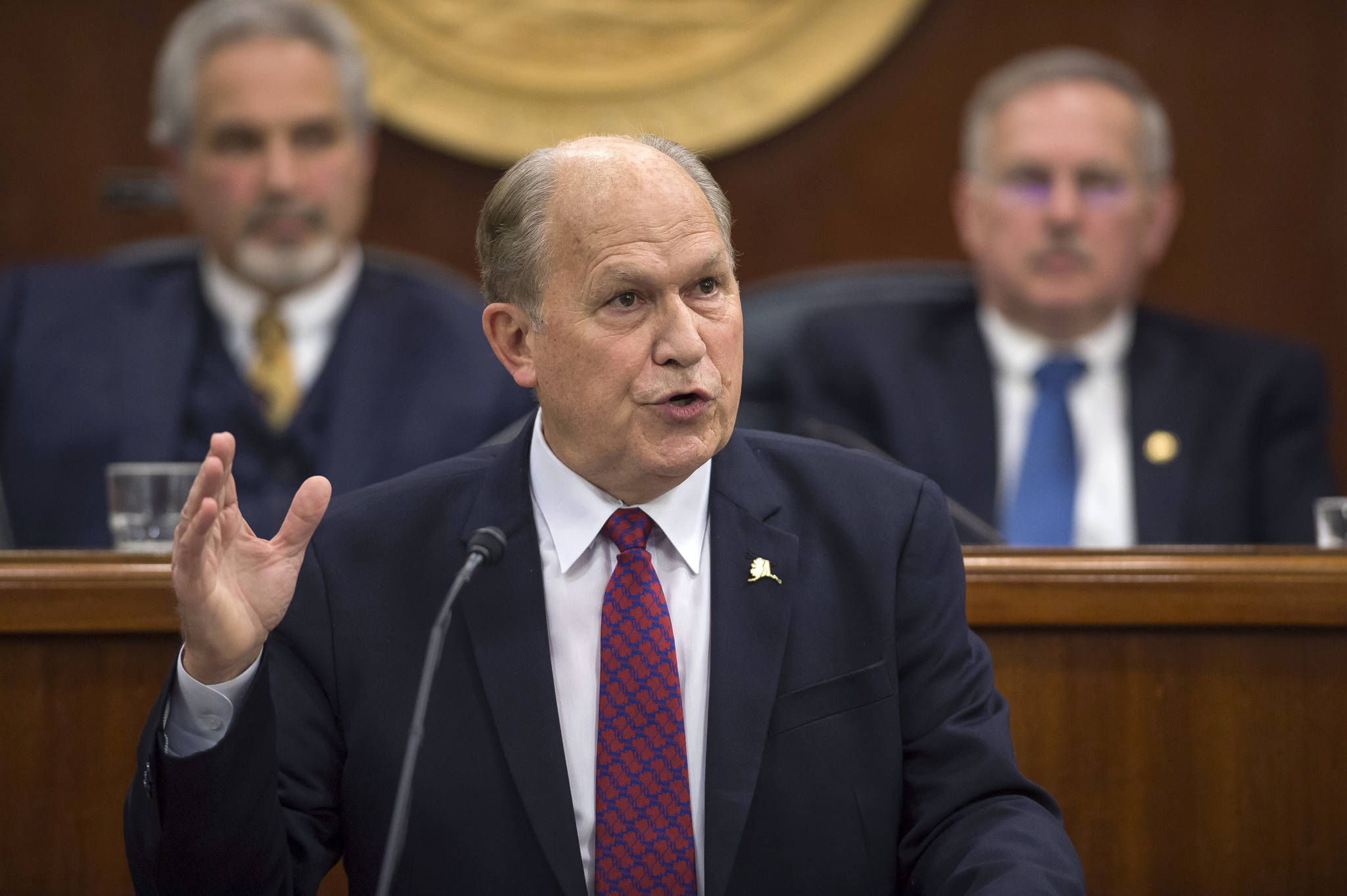 Gov. Bill Walker speaks during his State of the State address before a joint session of the Alaska Legislature at the Capitol on Thursday, Jan. 18, 2018. Senate President Pete Kelly, R-Fairbanks, left, and Speaker of the House Bryce Edgmon, D-Dillingham, watch from the Speakers desk in the background. (Michael Penn | Juneau Empire)