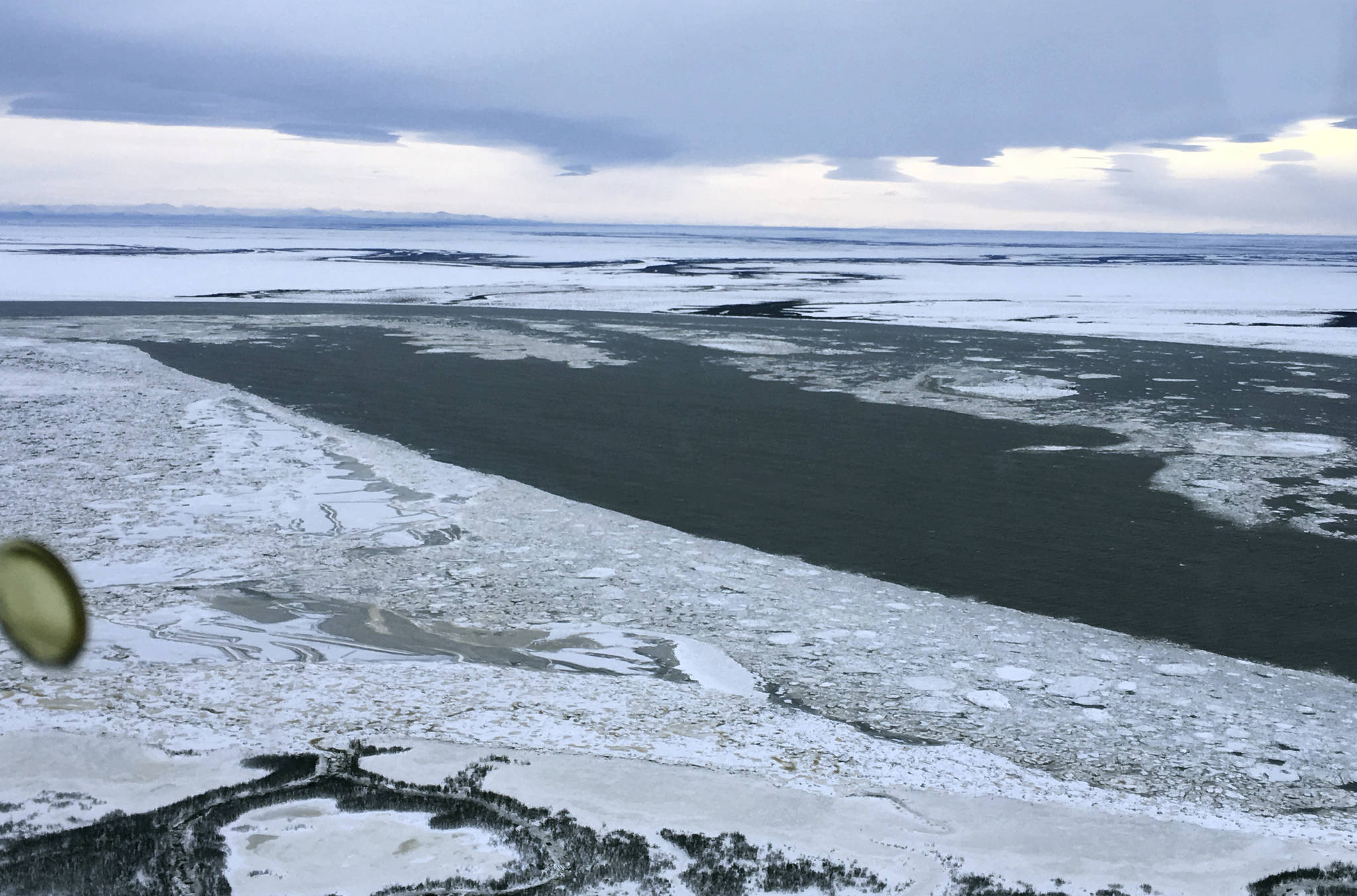 This January, 2018 photo provided by Bethel Search and Rescue shows a portion of the Kuskokwim River near Bethel, Alaska, that is not covered by as much ice as it usually is this time of year. Months of higher-than-normal temperatures have opened dangerous holes in frozen rivers that rural Alaskans use as roads. One troublesome ice highway is the Kuskokwim River, where a man died New Year&rsquo;s Eve after driving his snowmobile into a hole. (Bethel Search and Rescue)