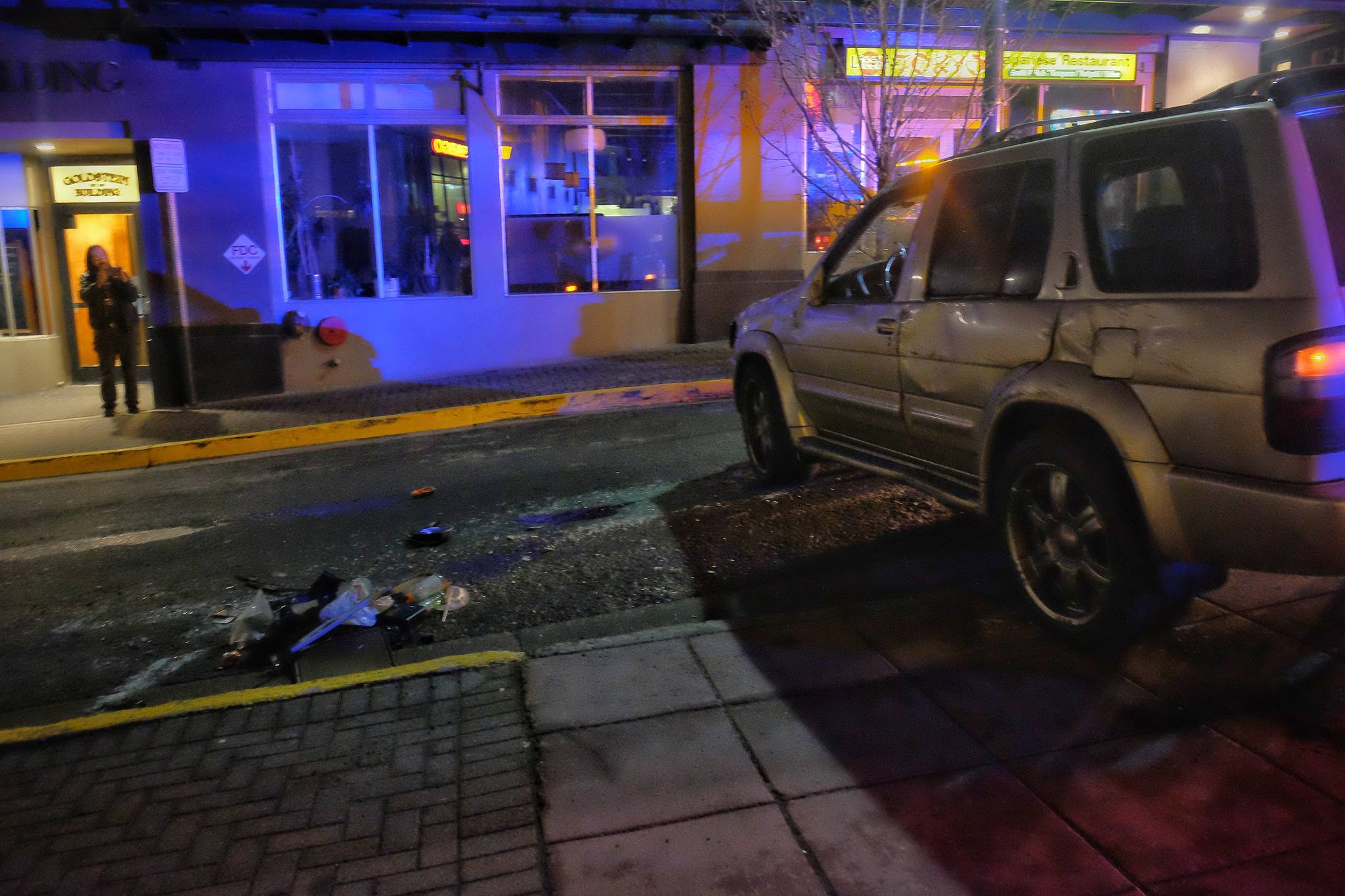 An SUV sits on Seward Street with a concrete planter at the corner of Seward Street and Second Street on Thursday night. The driver and sole passenger were taken to the hospital for injuries that were not life-threatening. (Courtesy photo | Jessie Herman-Haywood)